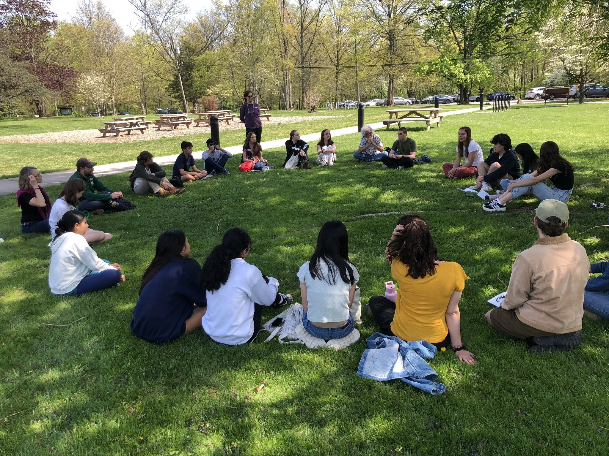 lk and kids in circle outside watershed event.jpeg
