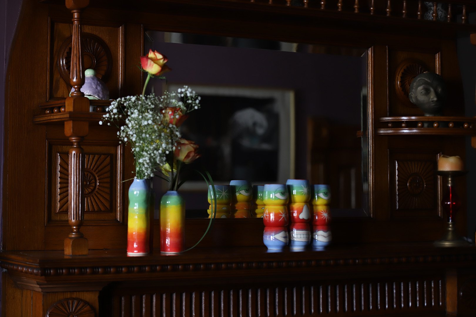 rainbow vases and face stacks in front of mirror.jpg