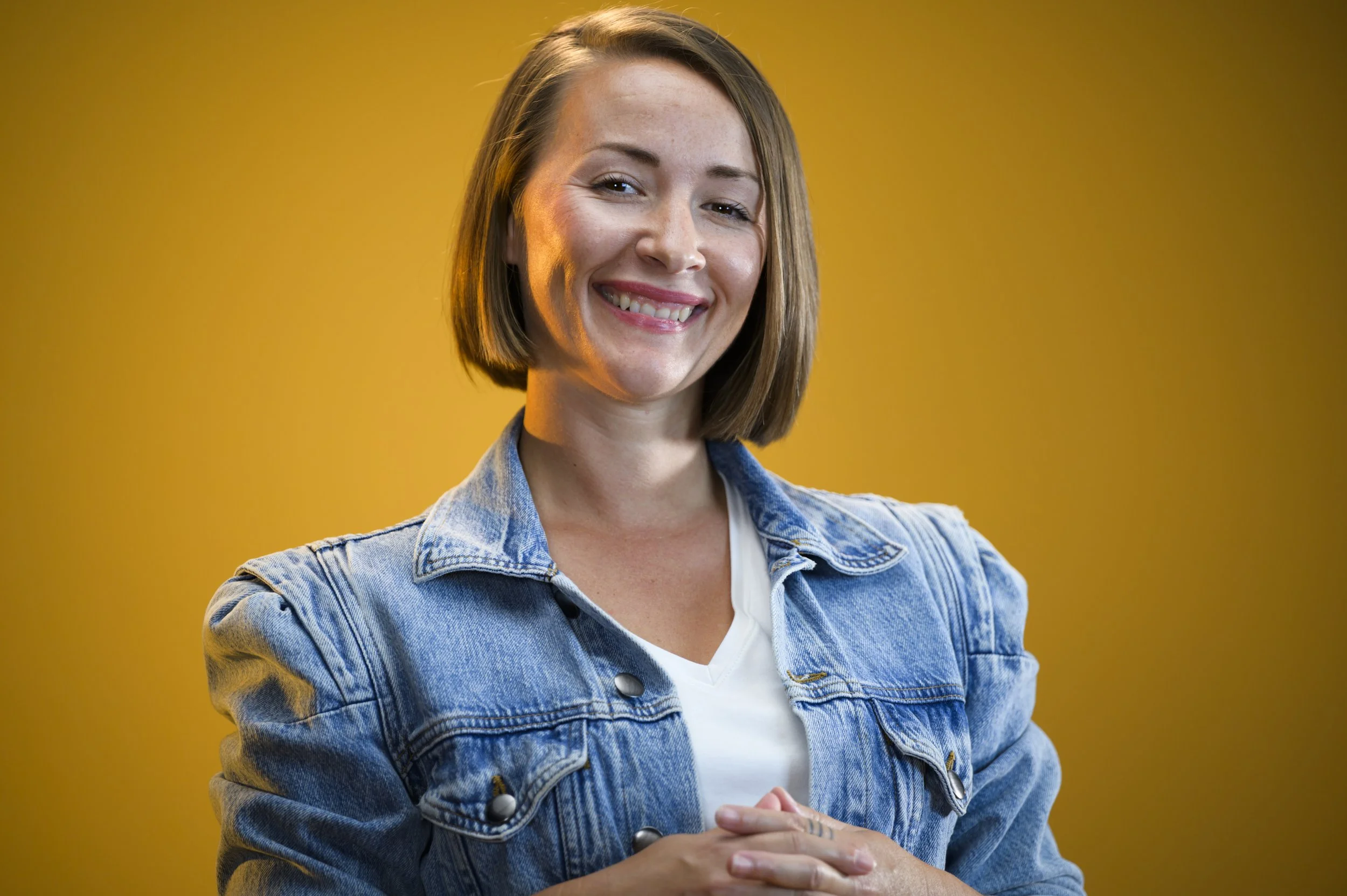 Photo of Many in front of a yellow background