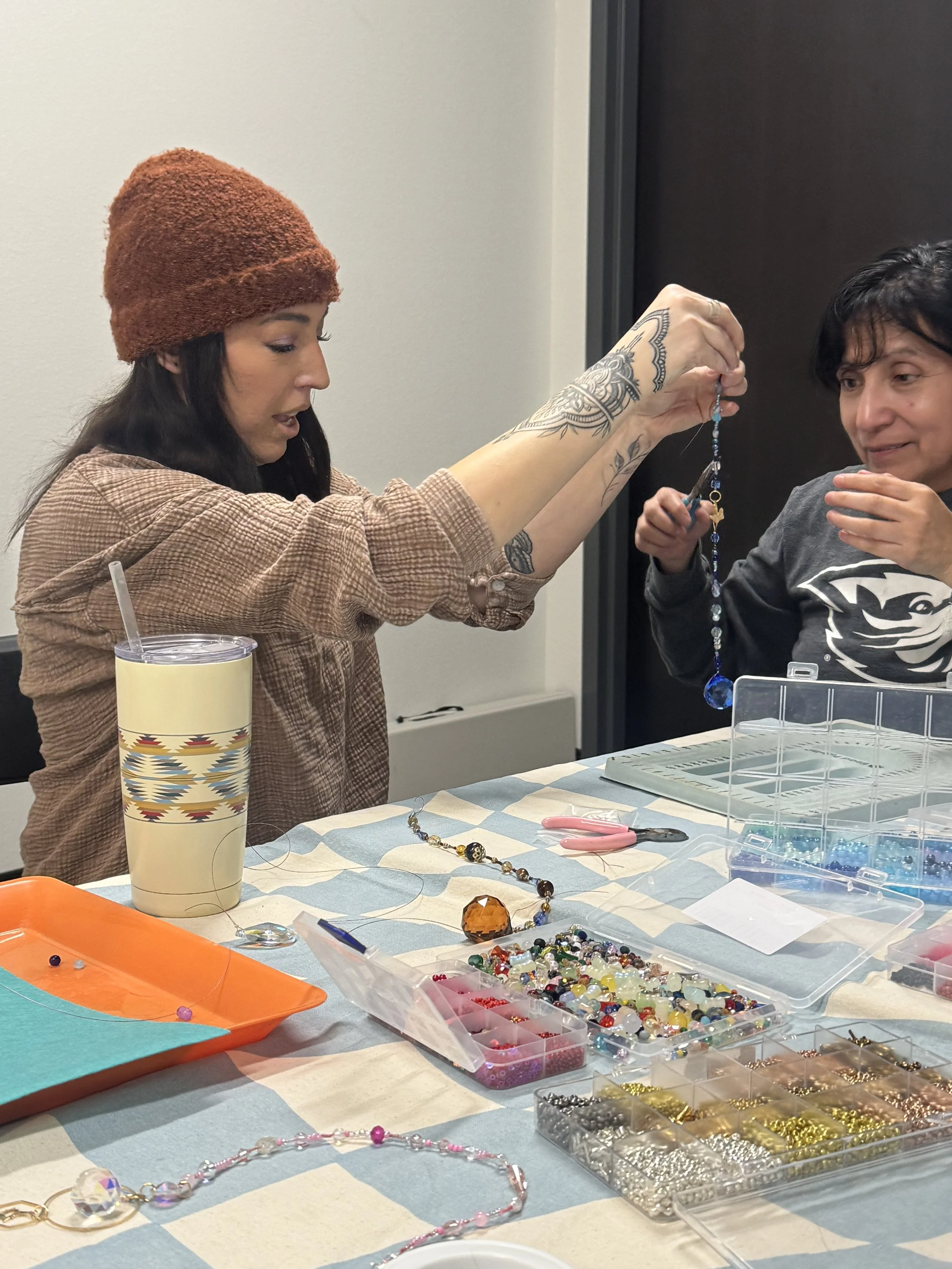 Visual artist Jessica Cherry demonstrates a craft to a participant at the March 2026 Movement & Making Community gathering at the AWC Community Center in Klamath CA