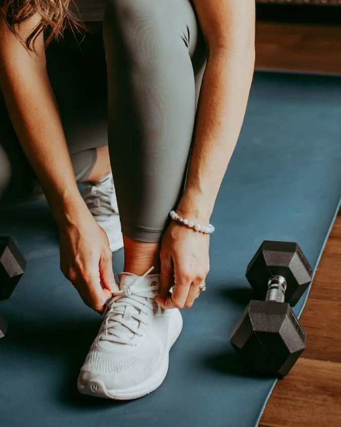 Weight loss plan for moms' coach Kylene tying her running shoes.