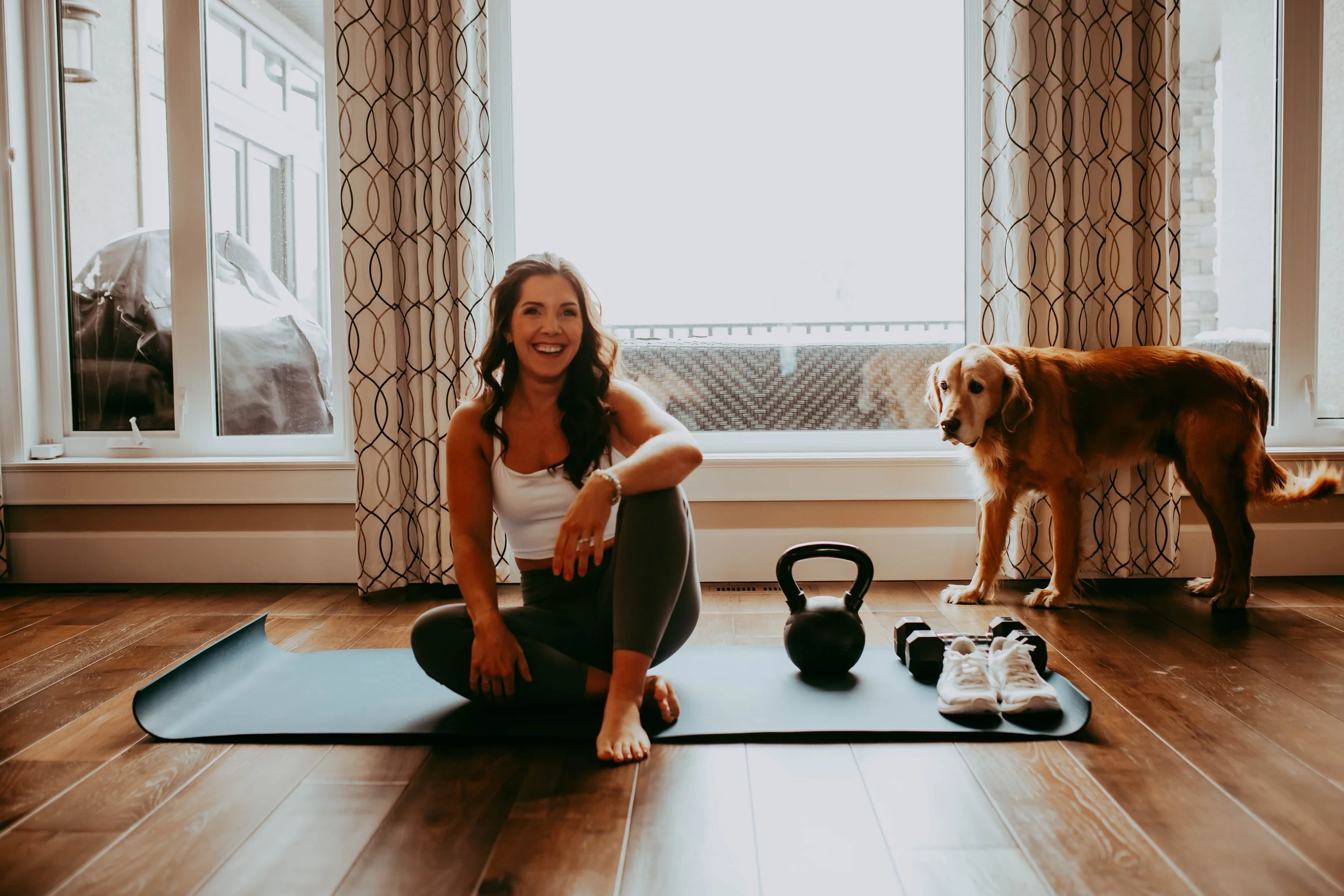 Kylene on her workout mat with the family dog