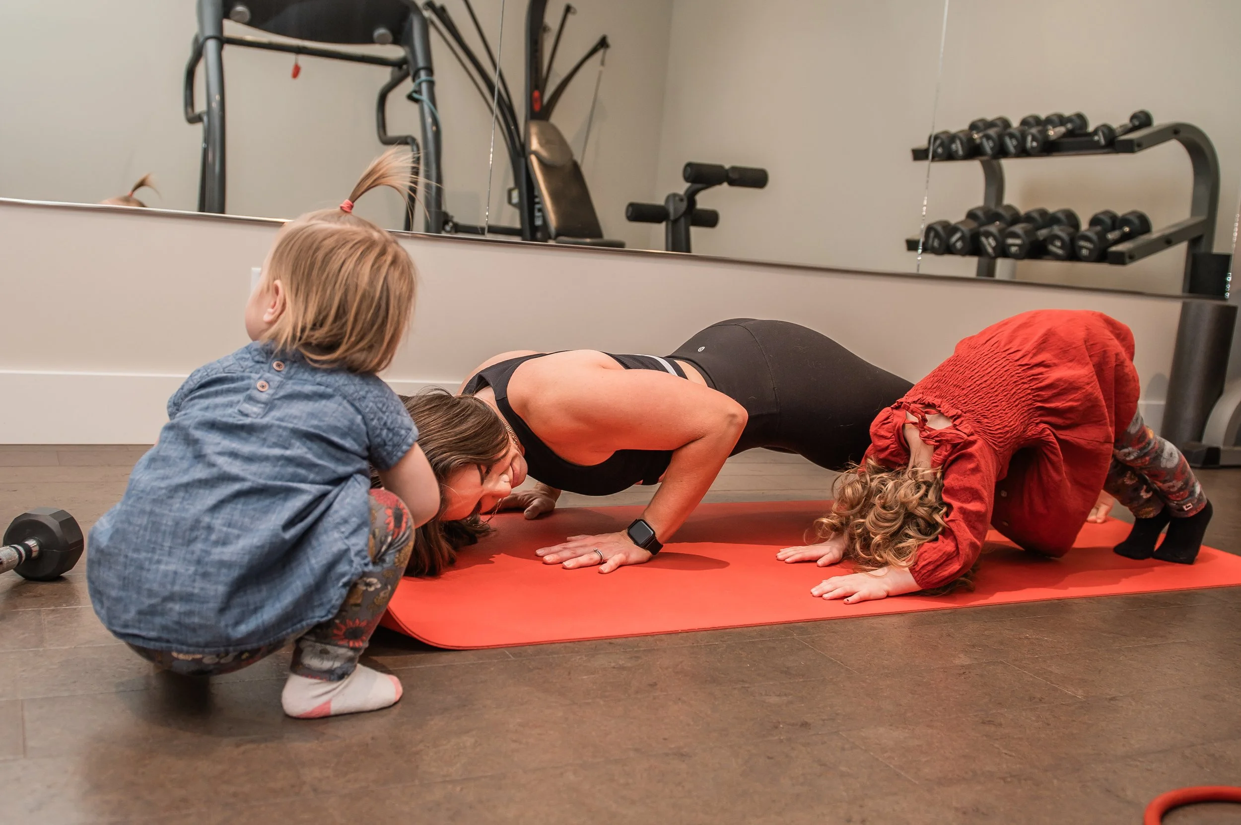 Mom and young kids practising yoga
