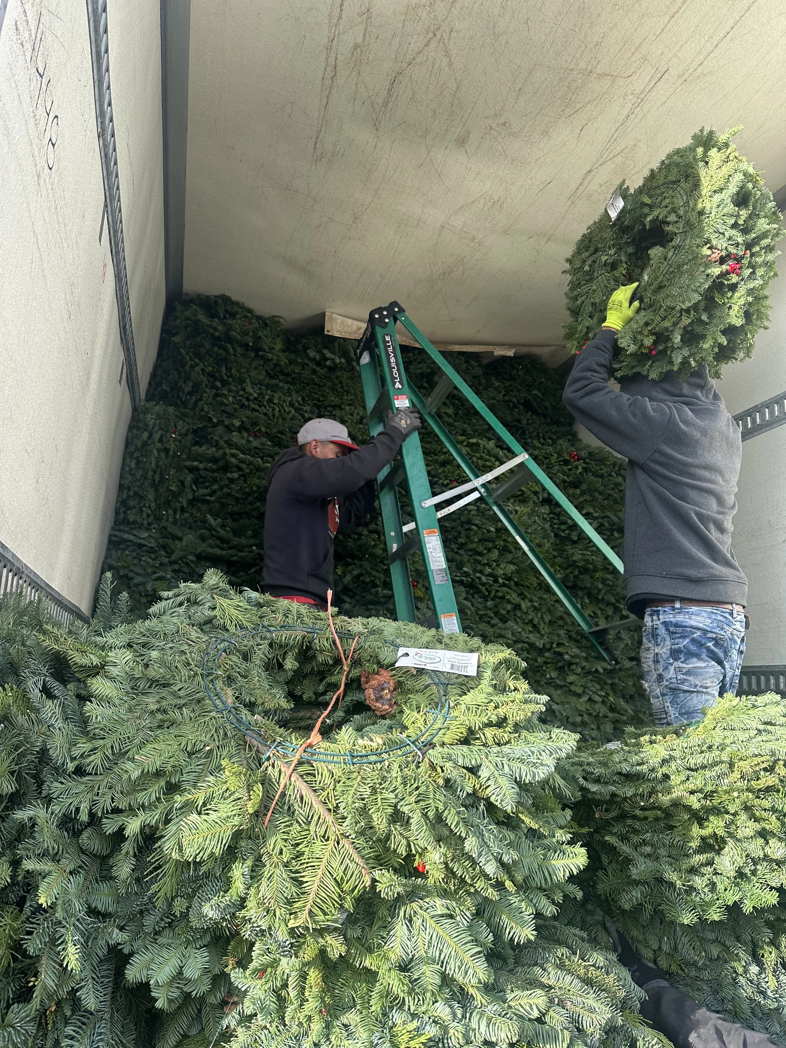 Hand loading wreaths.