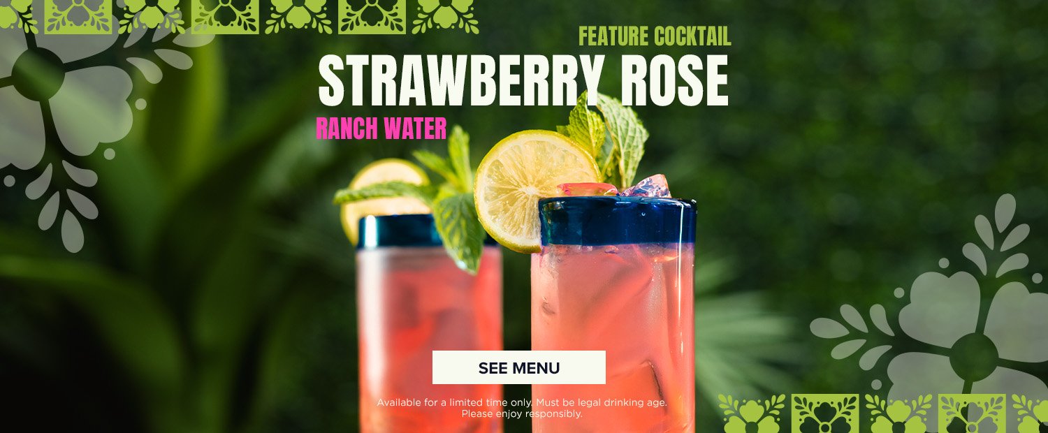 Two tall glasses of strawberry rose cocktail garnished with lemon slices and mint leaves, set against a blurred green background with decorative floral borders.