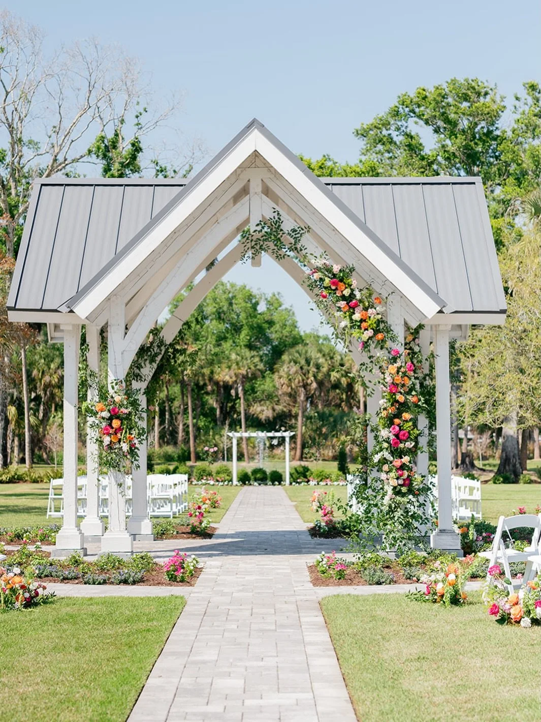 A stunning floral transformation elevated our Celebration Archway with the natural beauty of Florida blooms by Pura Vida Flower Farm, creating a sacred setting for a truly spectacular celebration 💐 &mdash; @celebration_grove | Premier Wedding &amp; 
