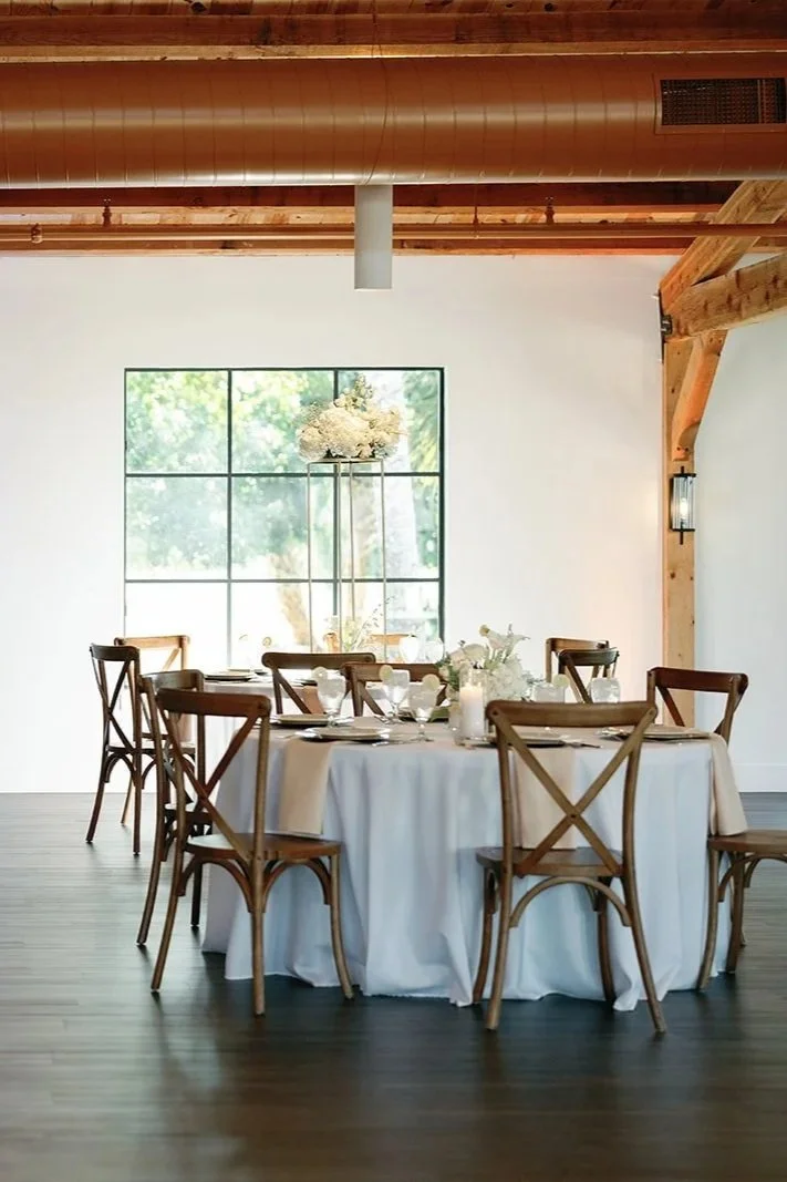 Air-conditioned reception hall at Celebration Grove in Vero Beach with customizable lighting, DJ space, dining tables, and dance floor for weddings and events.