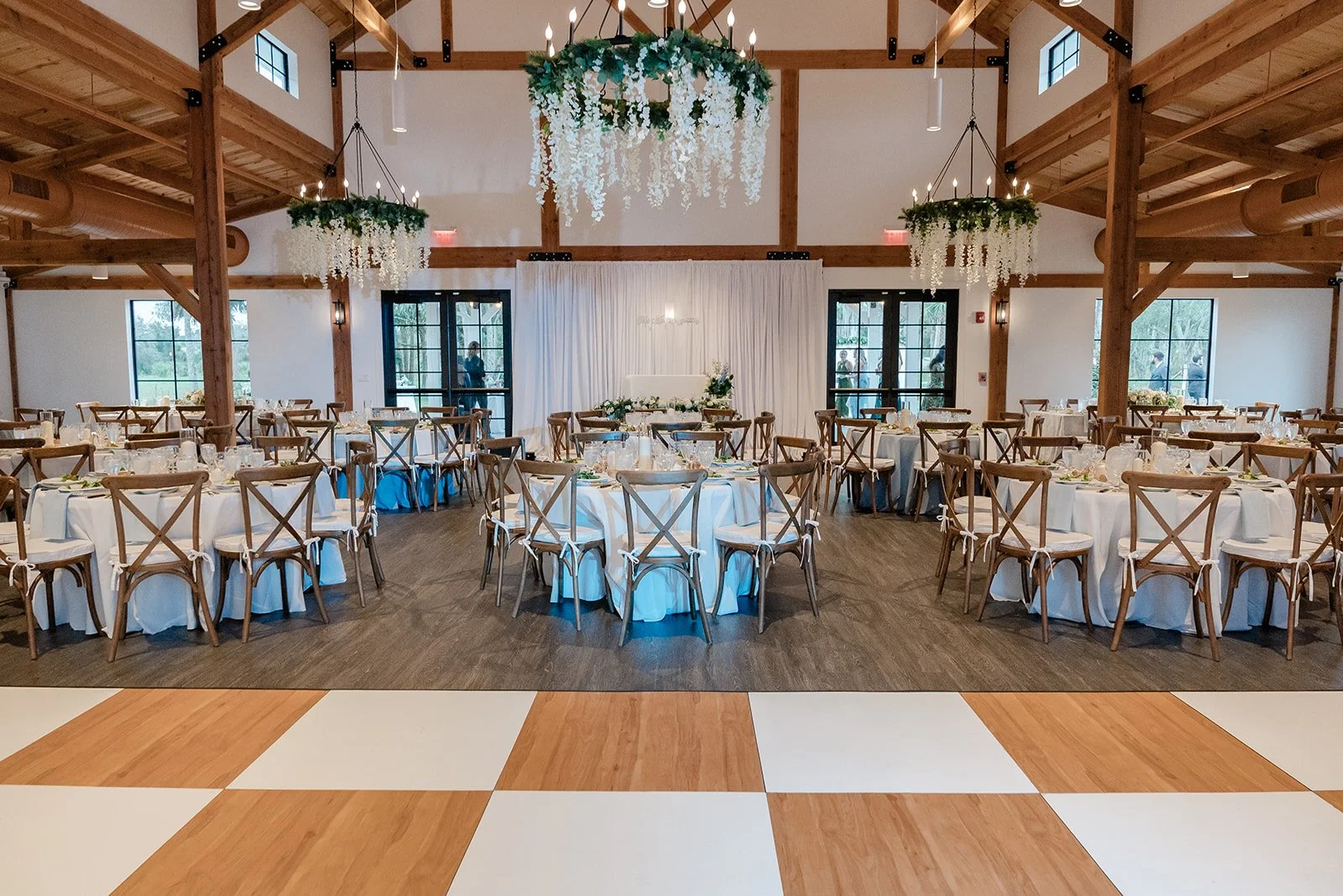 4,000 sq. ft. air-conditioned reception hall at Celebration Grove in Vero Beach with elegant tables and chairs for 200 guests, ideal for weddings, corporate retreats, banquets, and community celebrations.