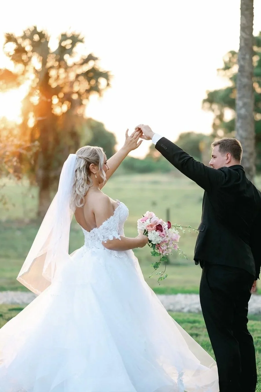 Golden hour at Celebration Grove in Vero Beach, FL bathes God’s fields in radiant light, as couples pose beneath the ancient oaks — a breathtaking backdrop for timeless wedding photography.