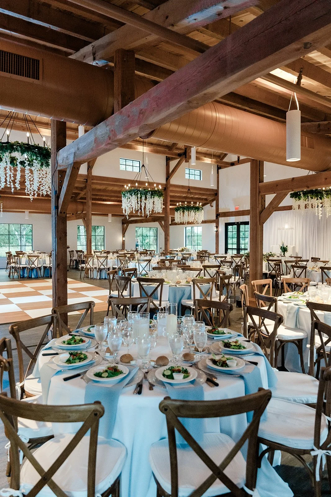 4,000 sq. ft. air-conditioned reception hall at Celebration Grove in Vero Beach with elegant tables and chairs for 200 guests, ideal for weddings, corporate retreats, banquets, and community celebrations.
