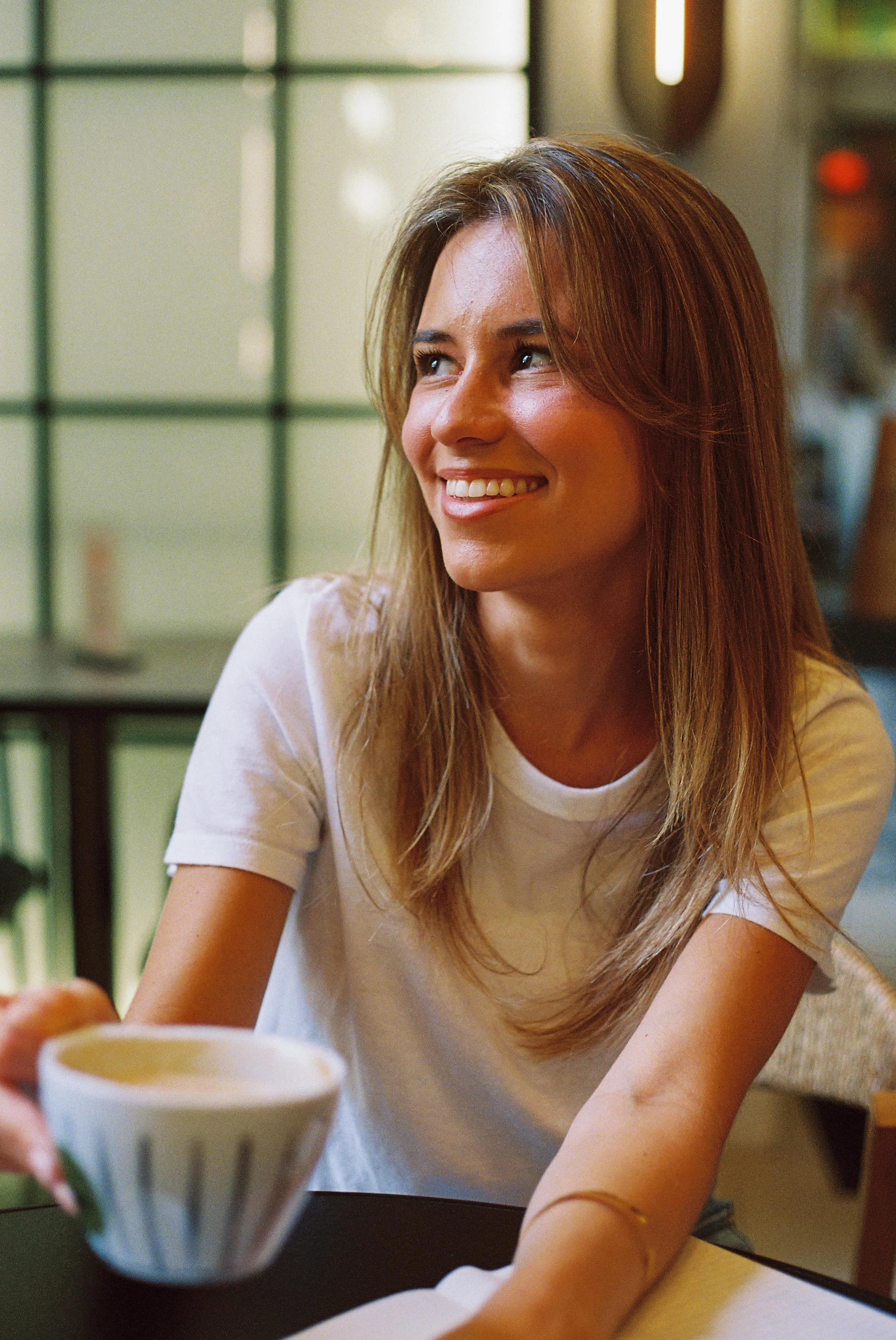 Woman smiling holding coffee