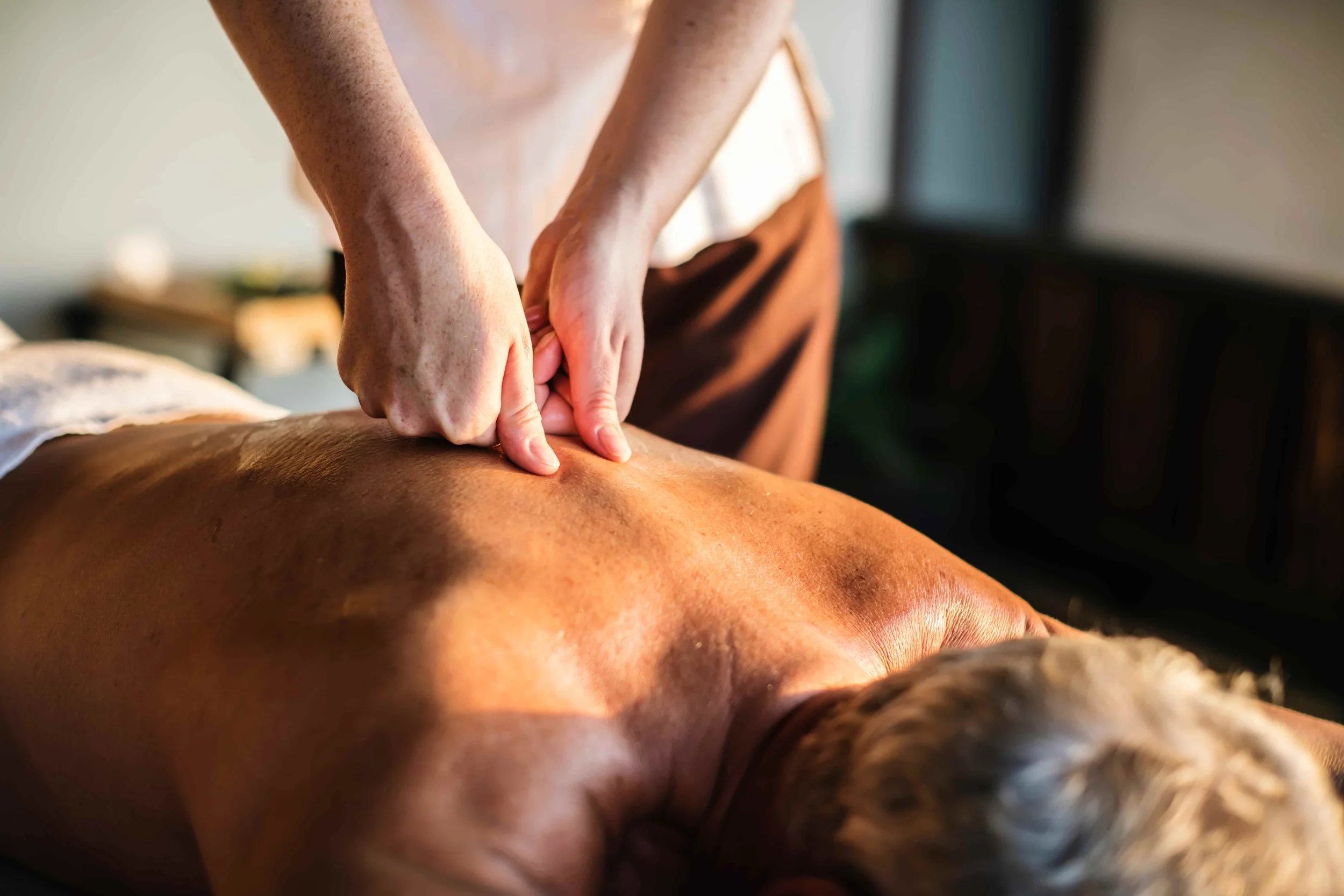Someone receiving a back massage.