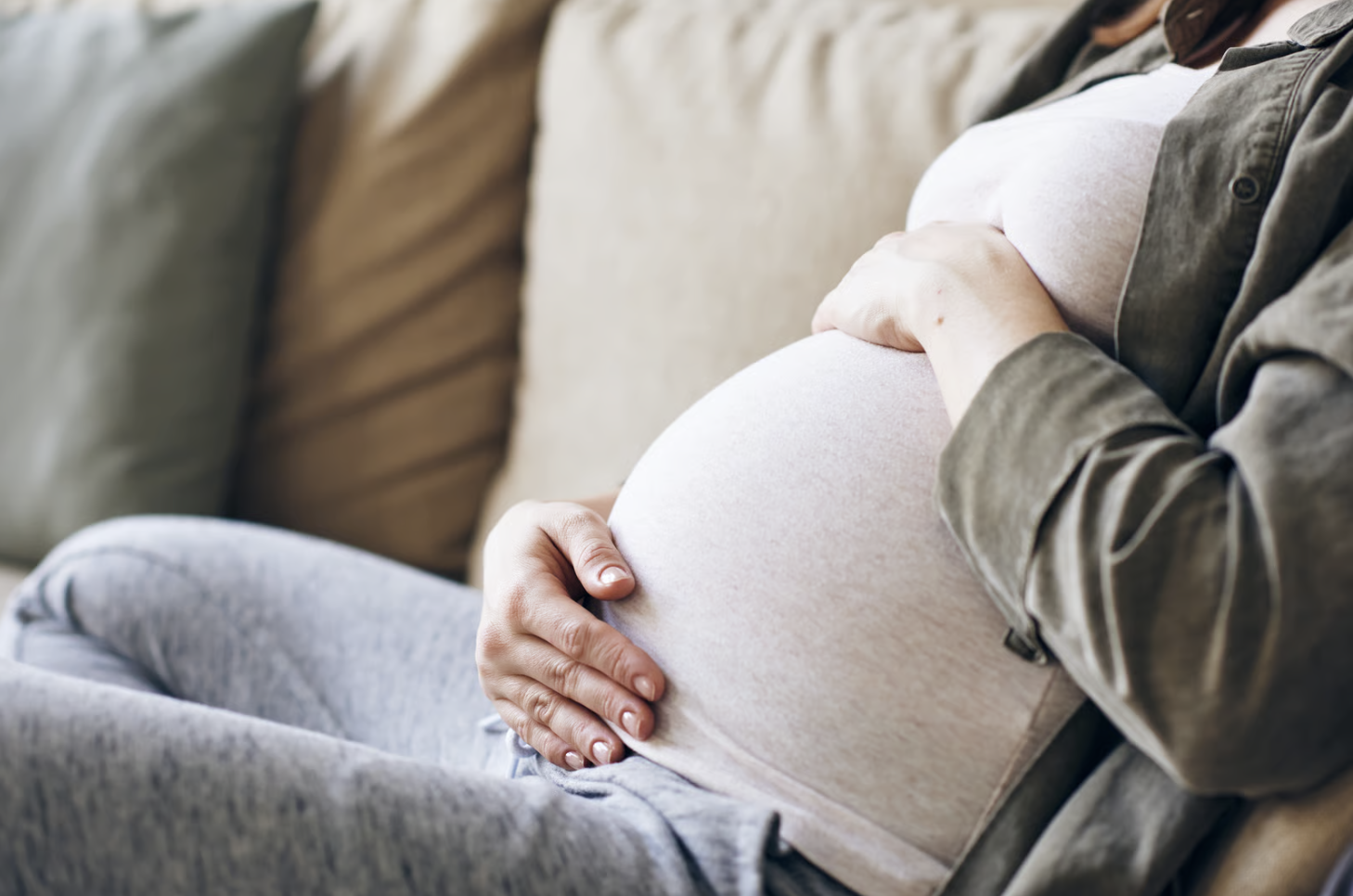A pregnant woman relaxing after receiving a massage.