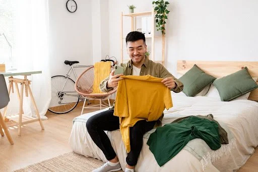 A man picking out a comfortable outfit to wear.