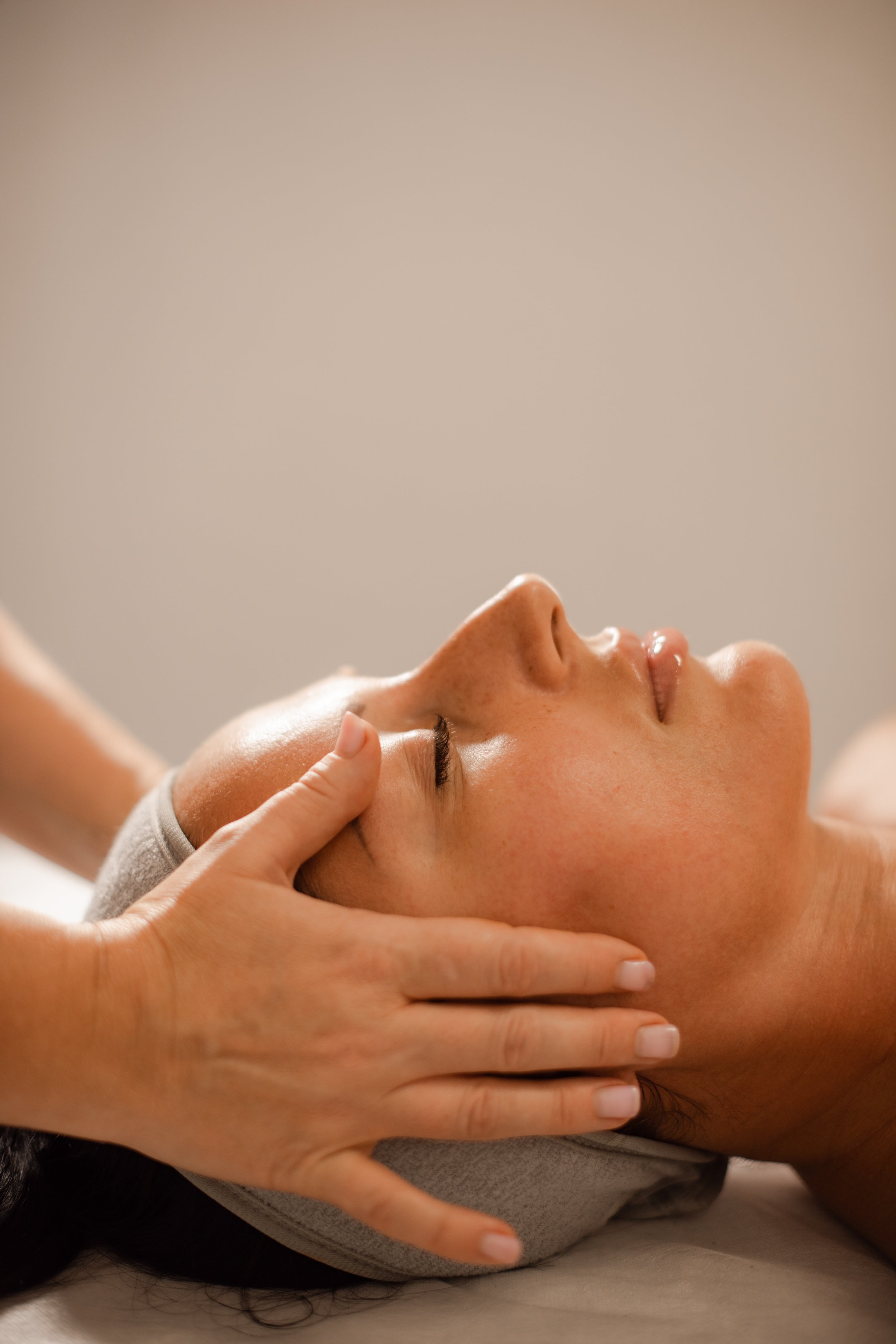 A woman getting her head massaged.