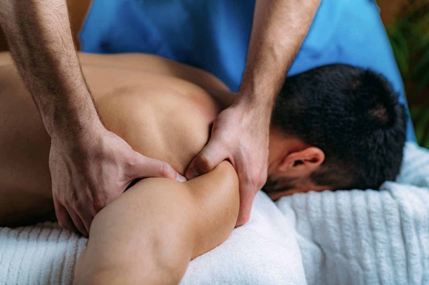 A man receiving a shoulder massage.