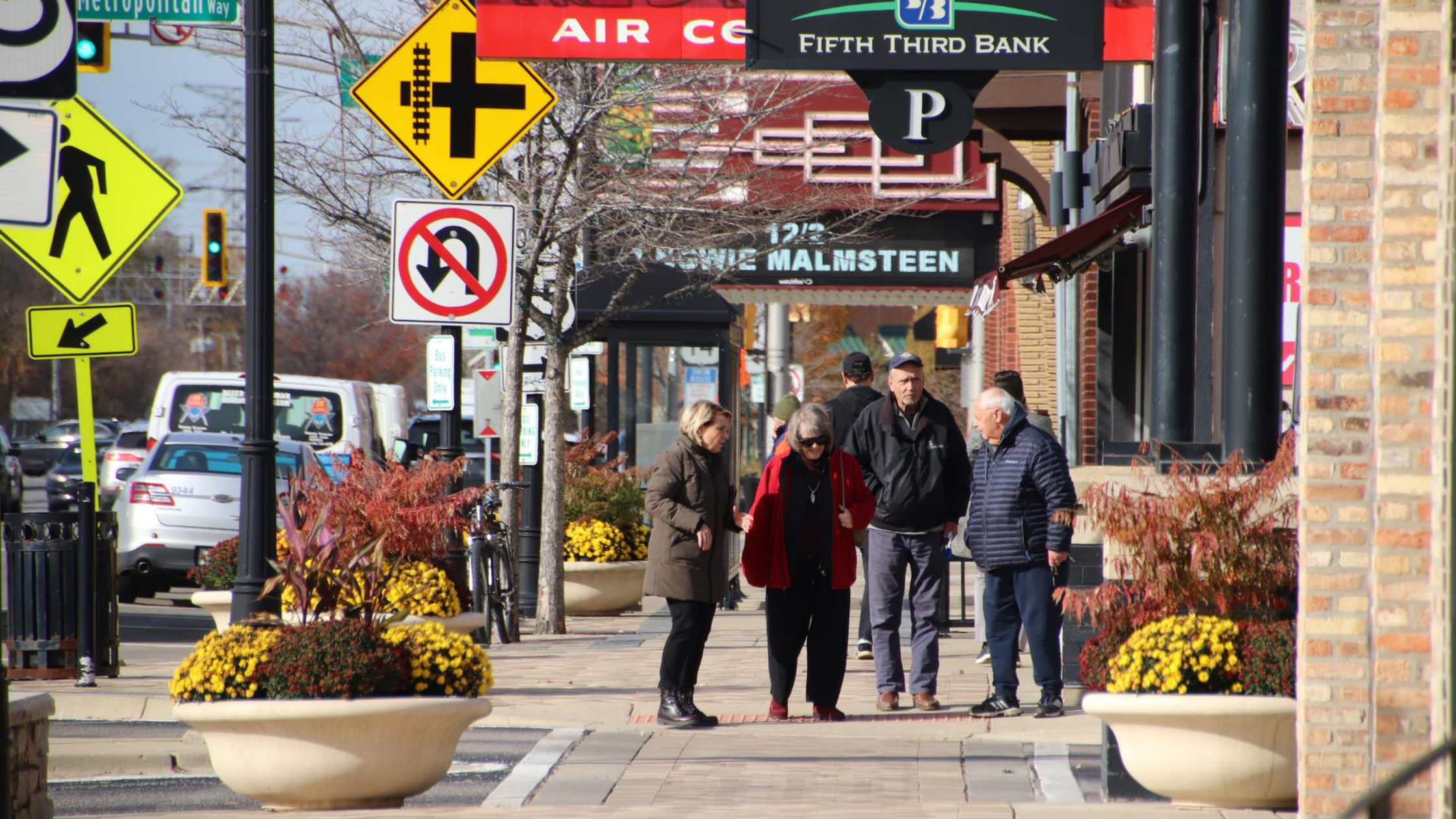 old people walking on sidewalk