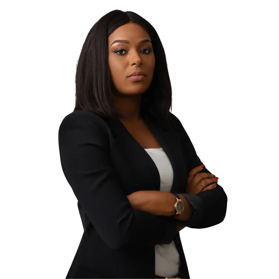 A confident African American woman with shoulder-length black hair, wearing a black blazer and white top, stands with arms crossed against a black background.