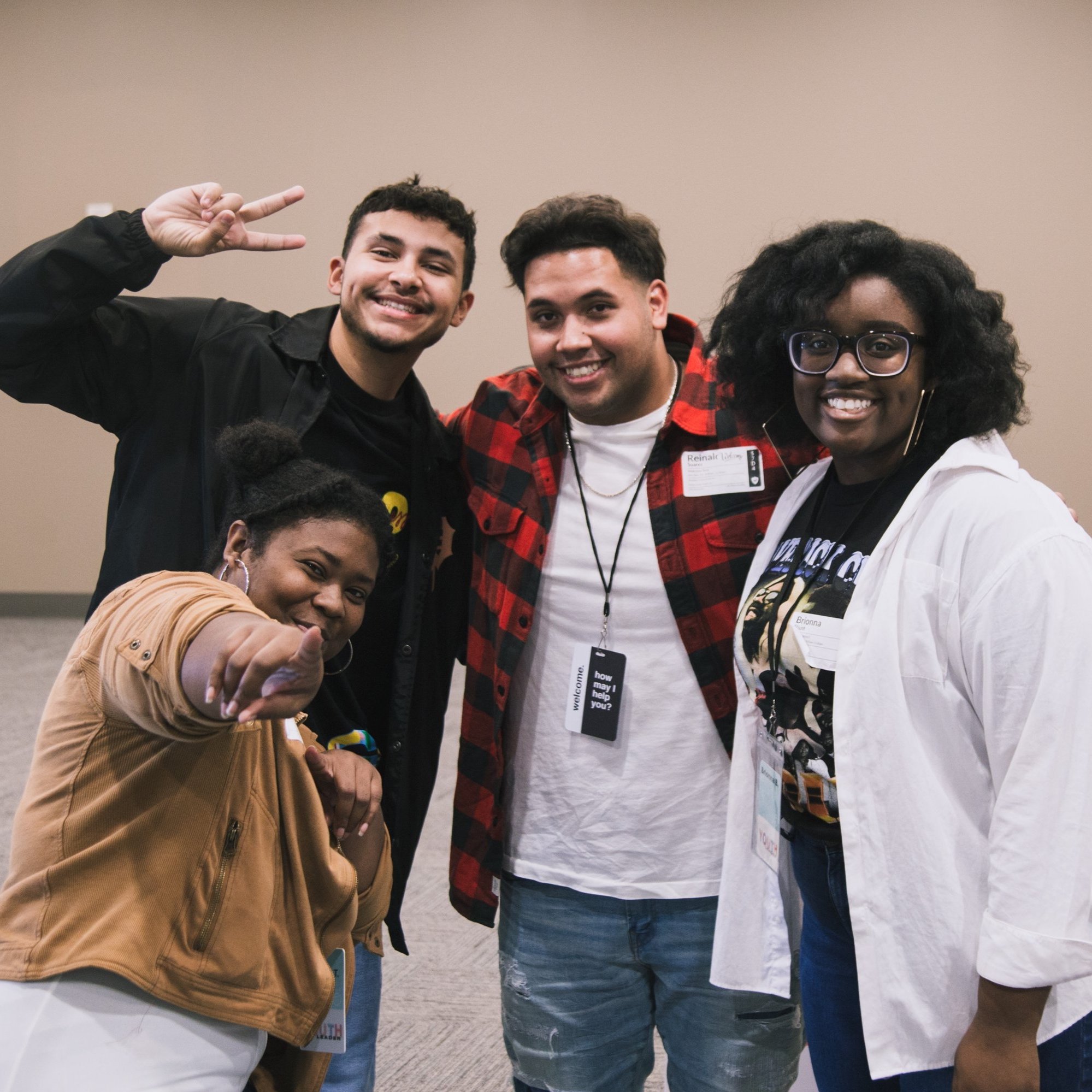  young adults smiling and posing together at church 