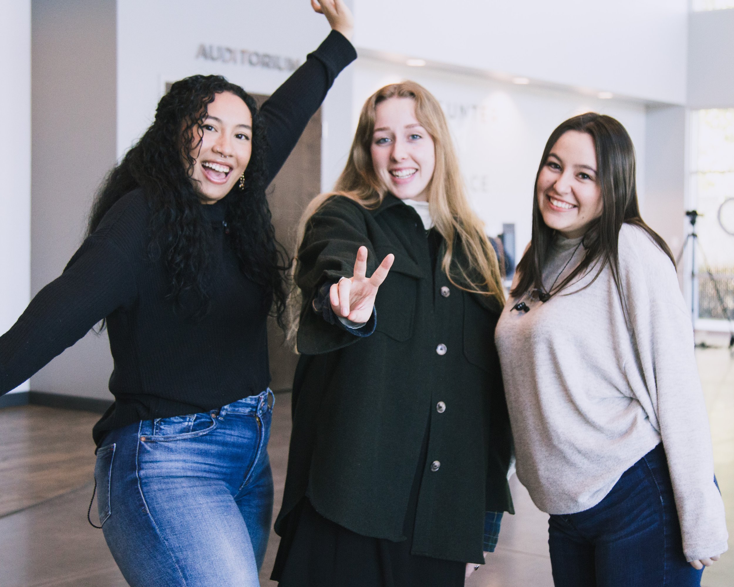  three women playfully posing at church together 