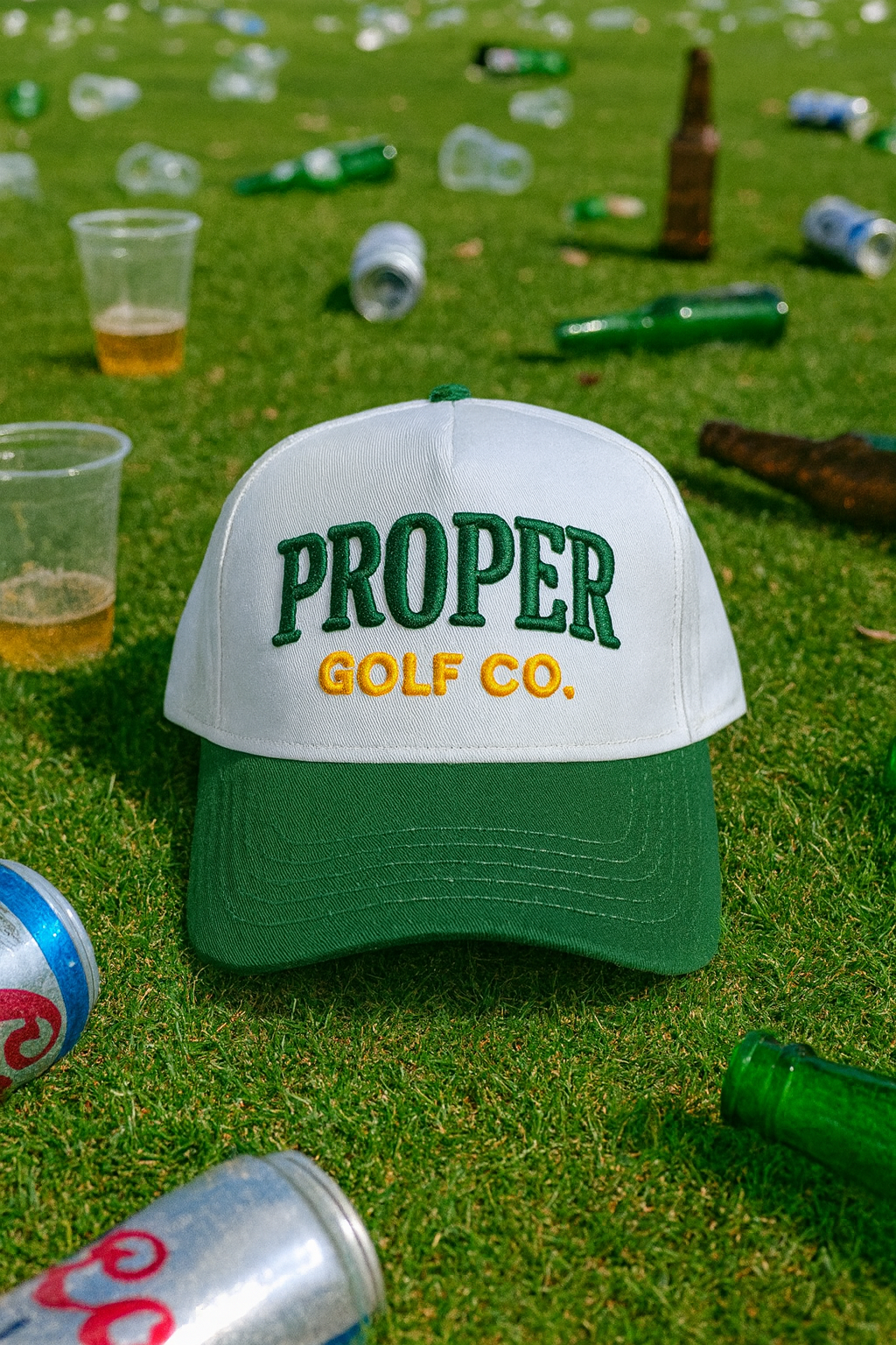 Golf Cap Amidst Littered Grass.png