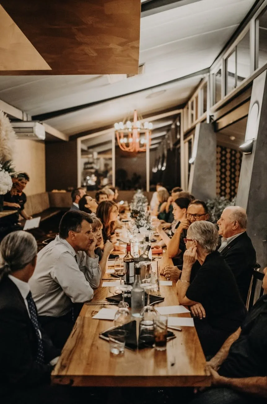 Group dining at La Sosta Fremantle featuring guests sharing a meal around a long table in a warm Italian restaurant setting, ideal for group bookings and private functions.