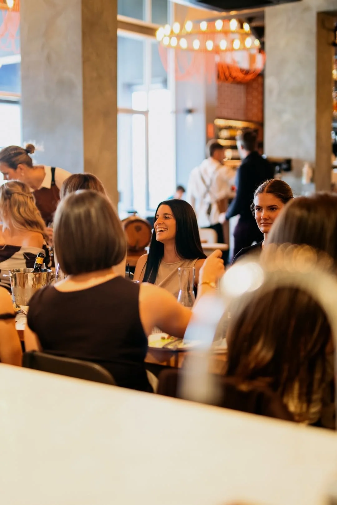 Corporate dinner at La Sosta Fremantle with guests enjoying a lively group dining experience in a warm Italian restaurant setting.
