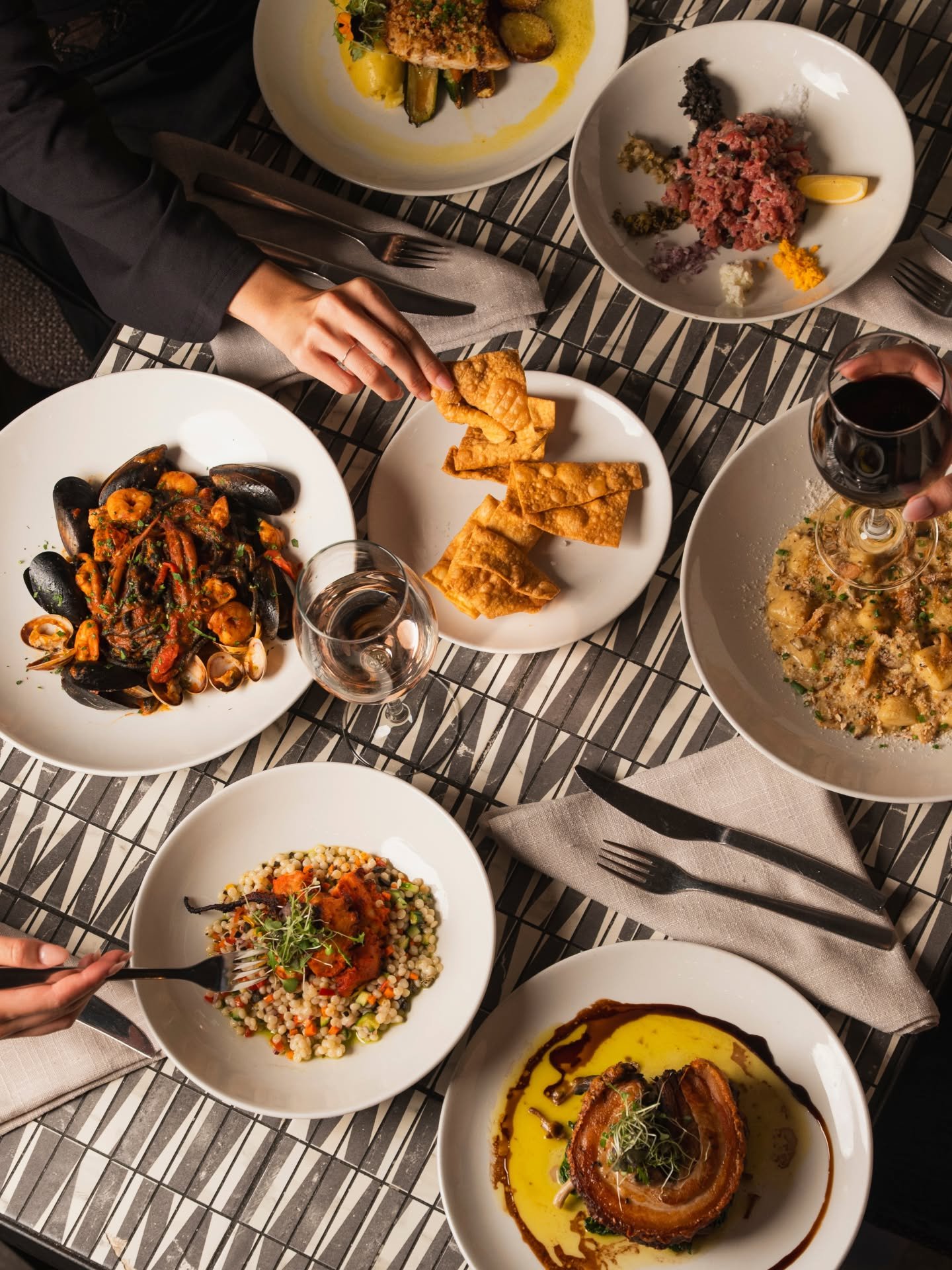 Shared Italian dinner at La Sosta, Fremantle: squid ink pasta with seafood, gnocchi, pork belly and red wine