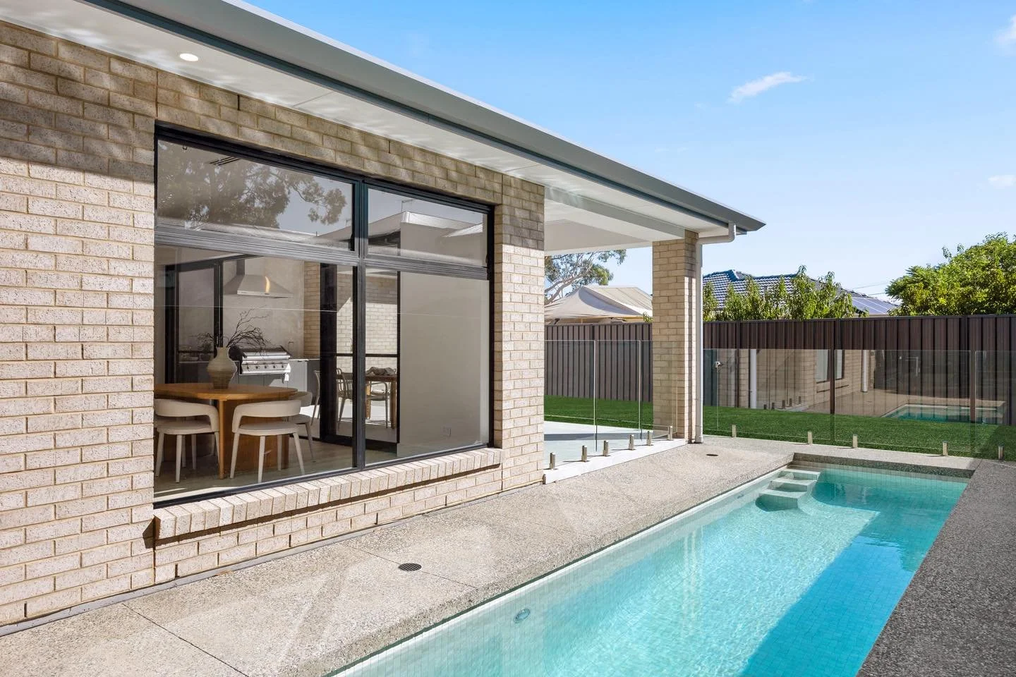 PARADISE II | Made for Family Pool Days

A custom concrete pool designed for easy, year-round enjoyment, complete with ceramic mosaic tiles and internal entry steps.

Salt &amp; Pepper exposed aggregate by premix_concrete surrounds the pool, adding t