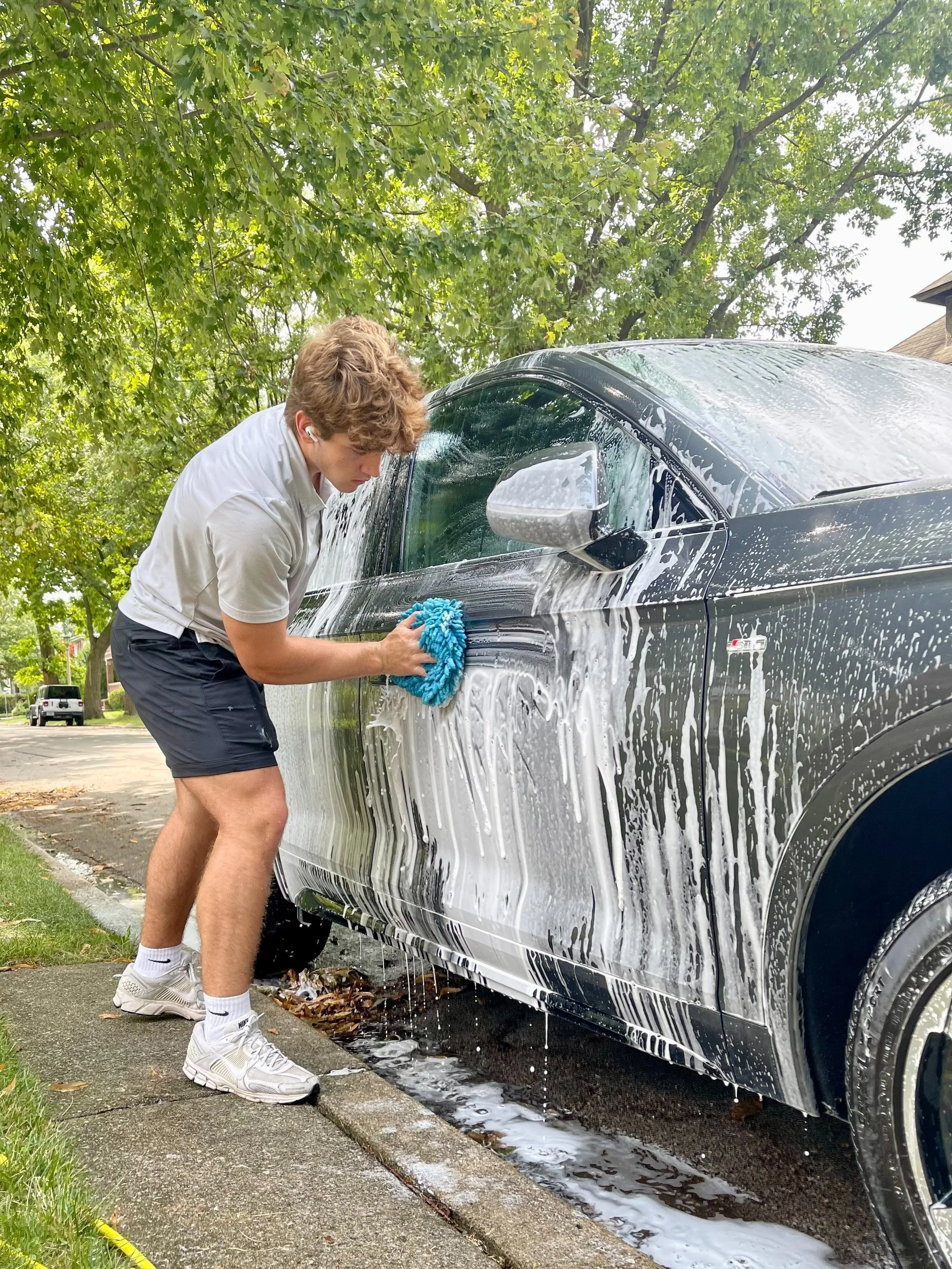 Pristine Detailing Owner Detailing a car mobile.