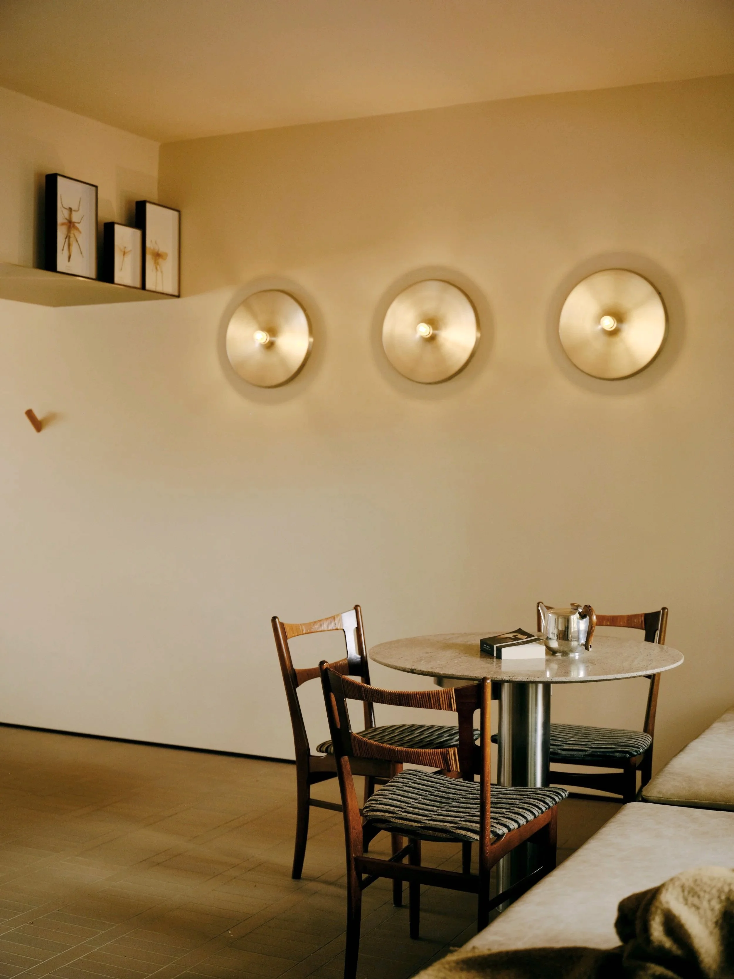 Hand spun feature wall lighting breaking the lines against this wall. A small space radically redefined into a contemporary nook.