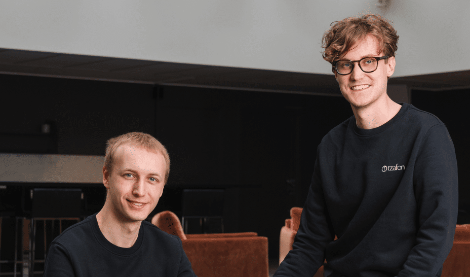 Two black and white portrait photos of young men, one with curly hair and a suit, the other with short hair and casual clothing.