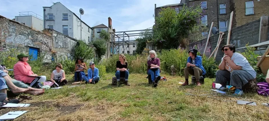 People seated outside some buildings