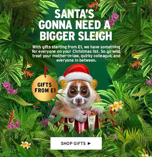 Christmas-themed advertisement featuring a lemur with a Santa hat holding gifts, surrounded by green foliage and flowers. Text reads "Santa's Gonna Need a Bigger Sleigh" with gift offers starting from Β£1. Button below says "Shop Gifts."