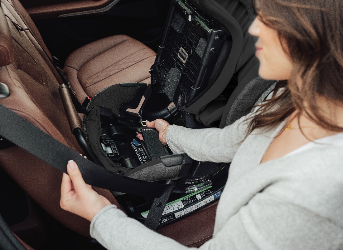 Installing a convertible car seat rear-facing in a vehicle.