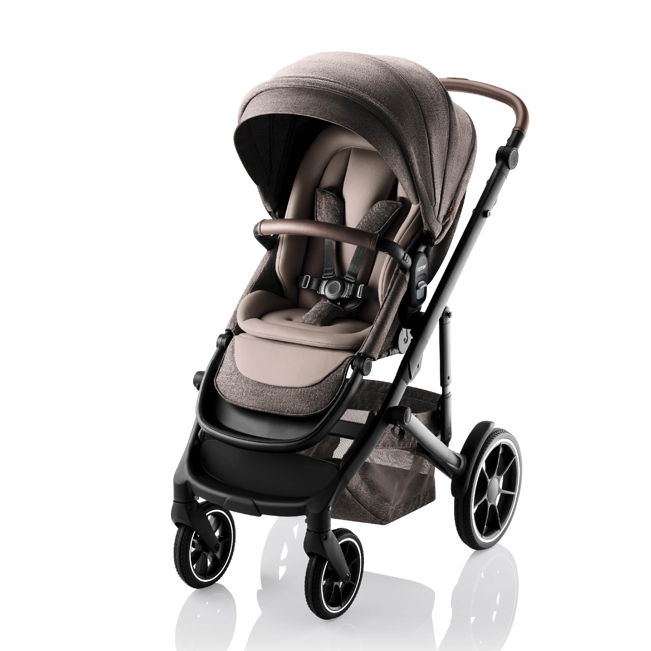 Brown and tan baby stroller with leather on the handlebar and bumper bar.