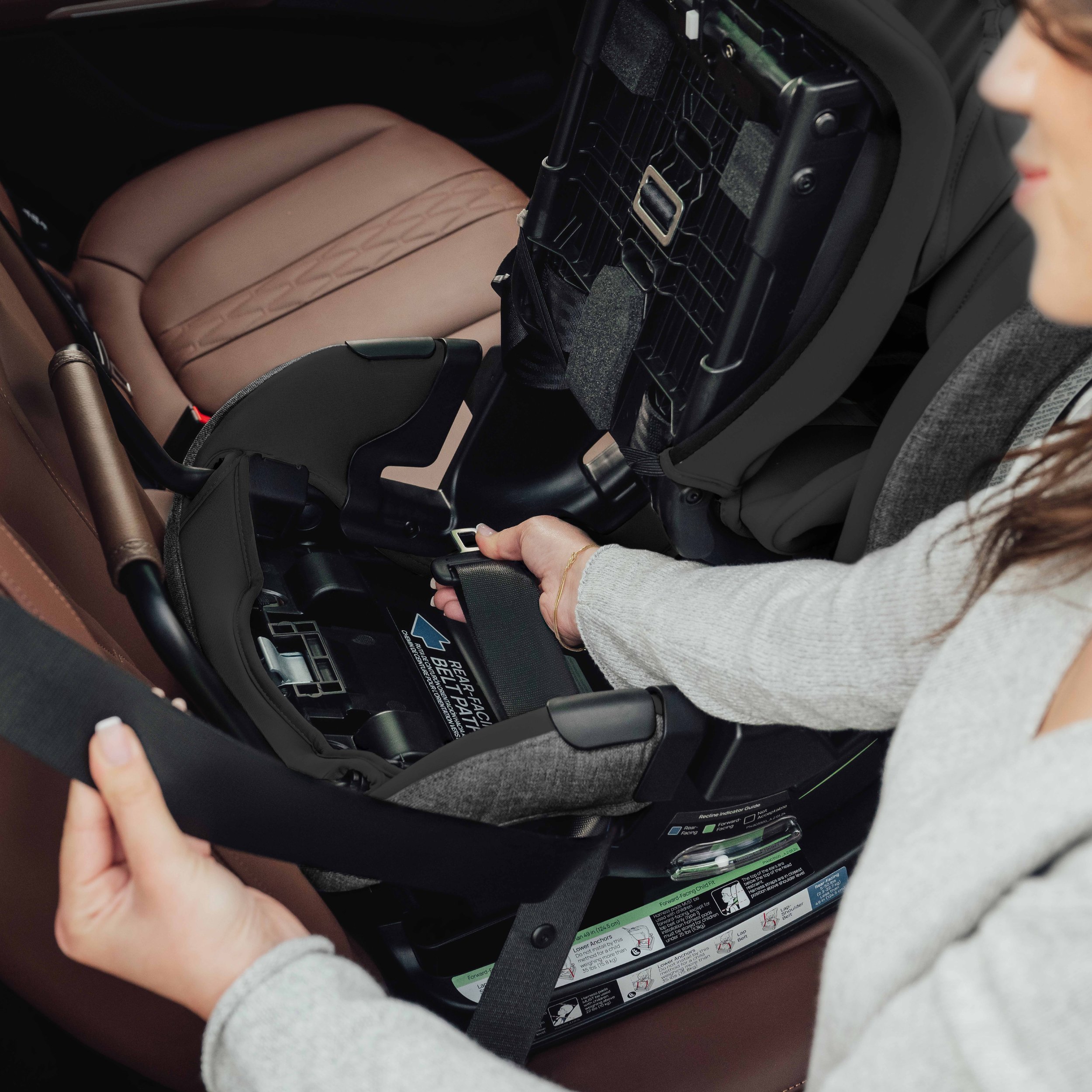 Installing a convertible car seat rear-facing in a vehicle.