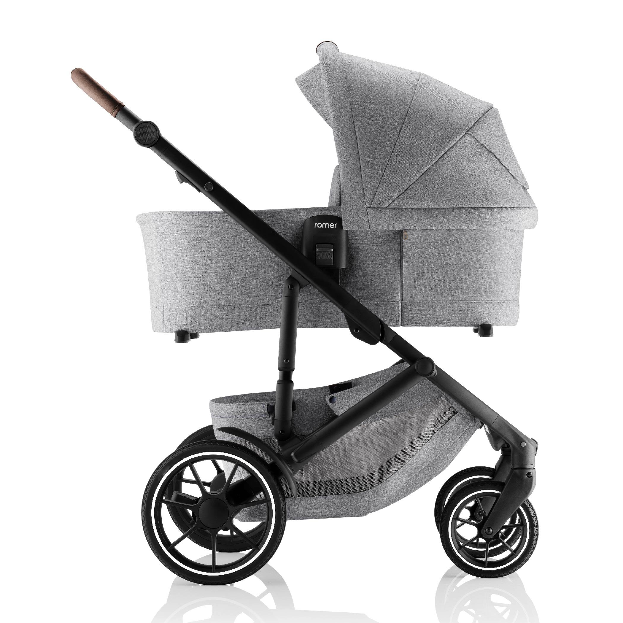 A grey baby bassinet attached to a stroller.