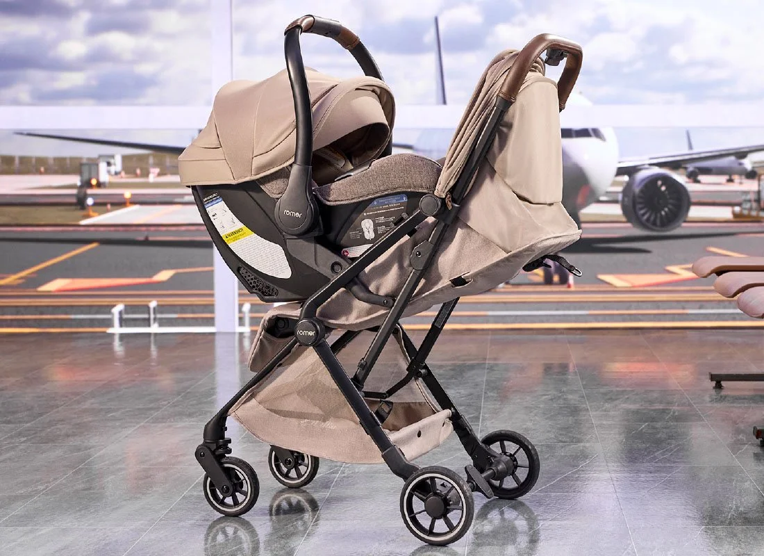 Tan Travel System in parent facing mode sitting i an airport lobby