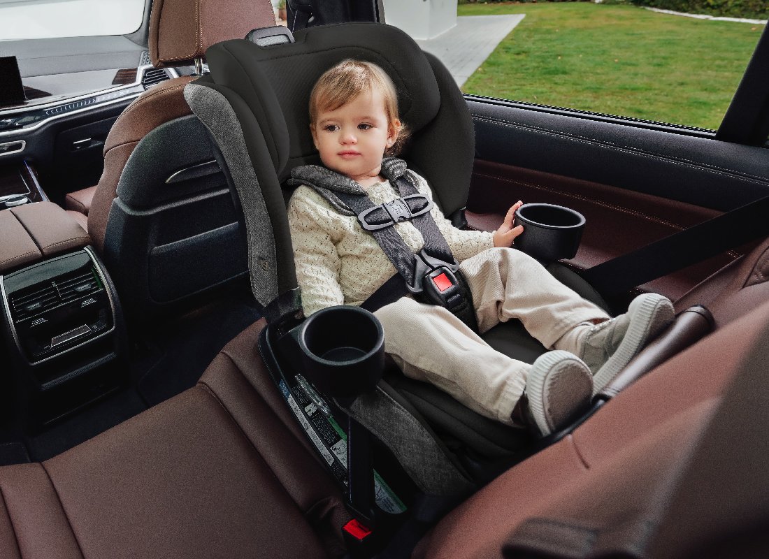 A toddler in a rear-facing car seat.