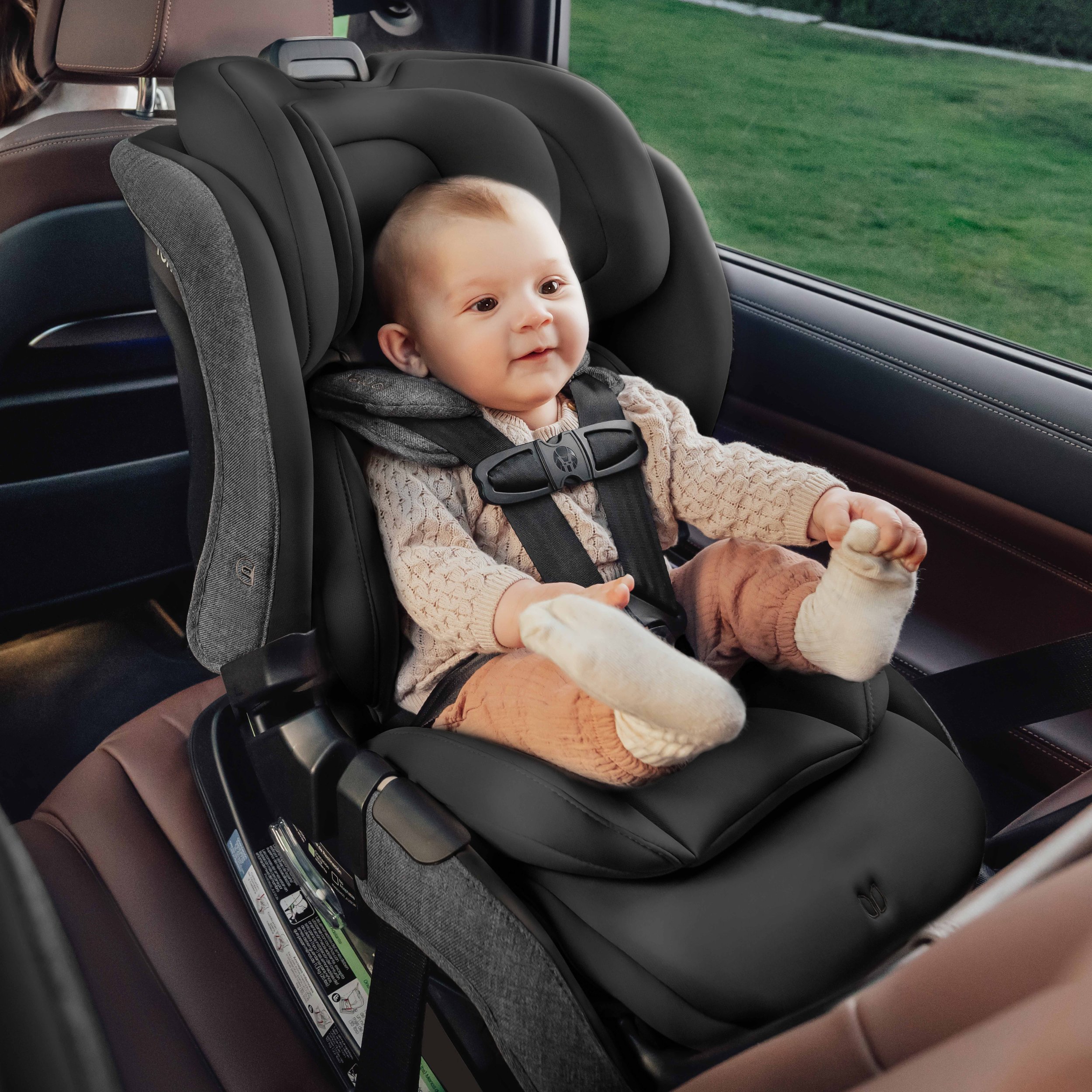 A baby in a rear-facing convertible car seat.