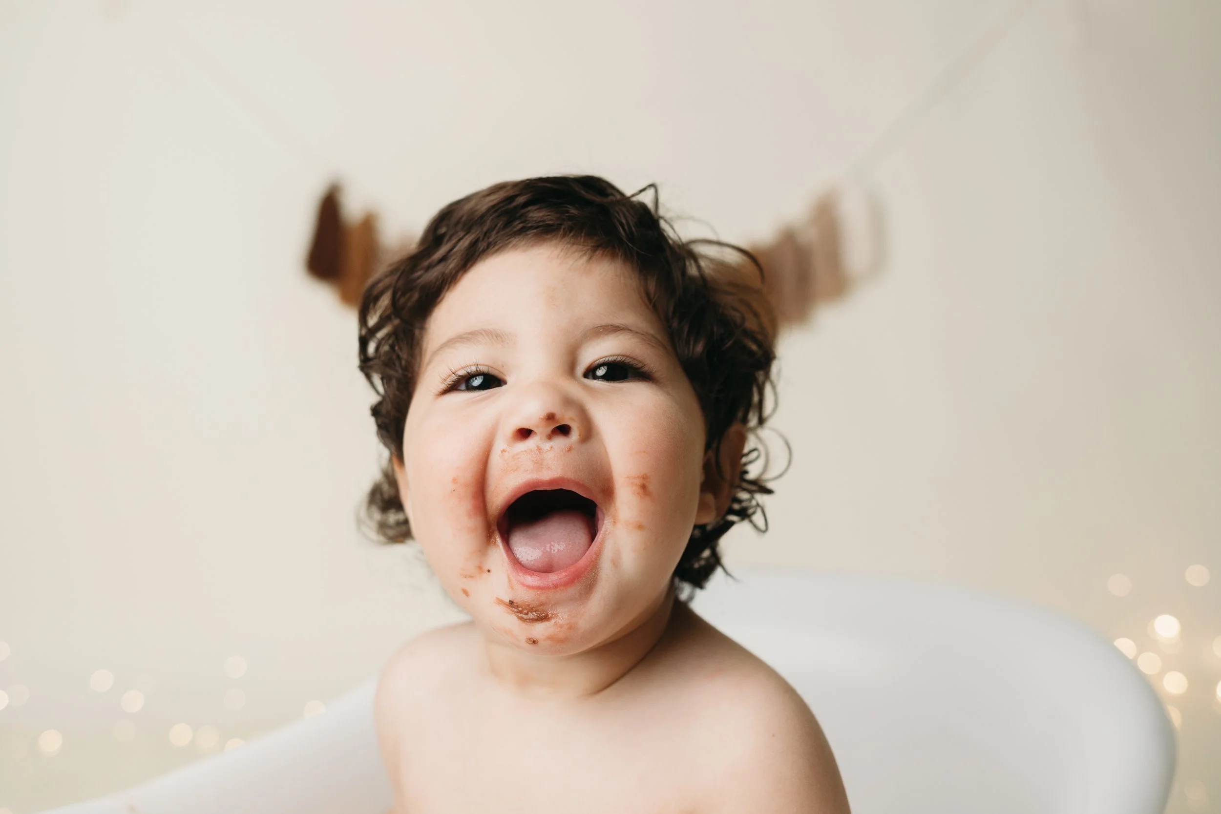 Psalm was the cutest for his splash portion of his cake smash session. Just look at him with his  open mouth, showing some food and crumbs on his face and chin, in our clawfoot tub.