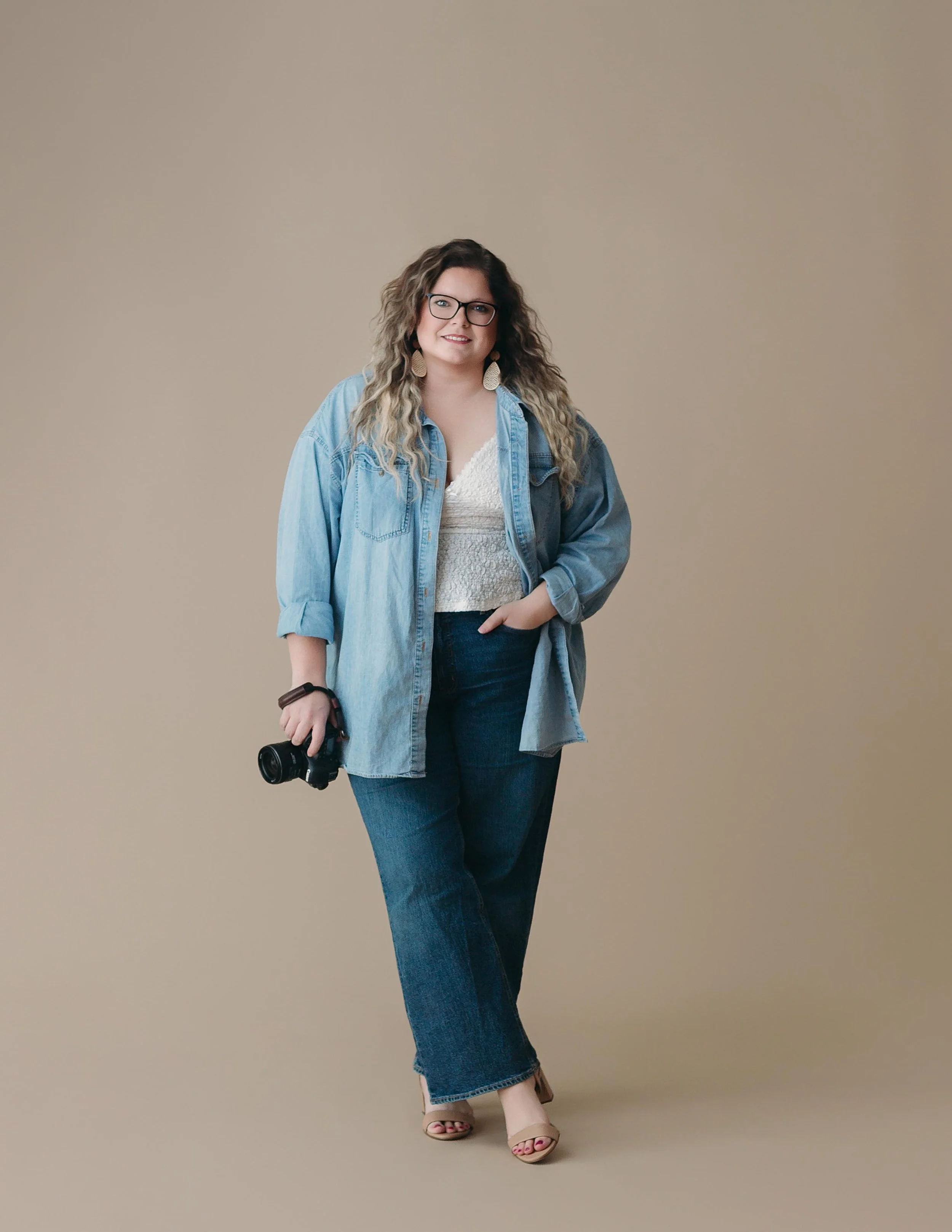 Headshot of me for clients to see me holding the camera.