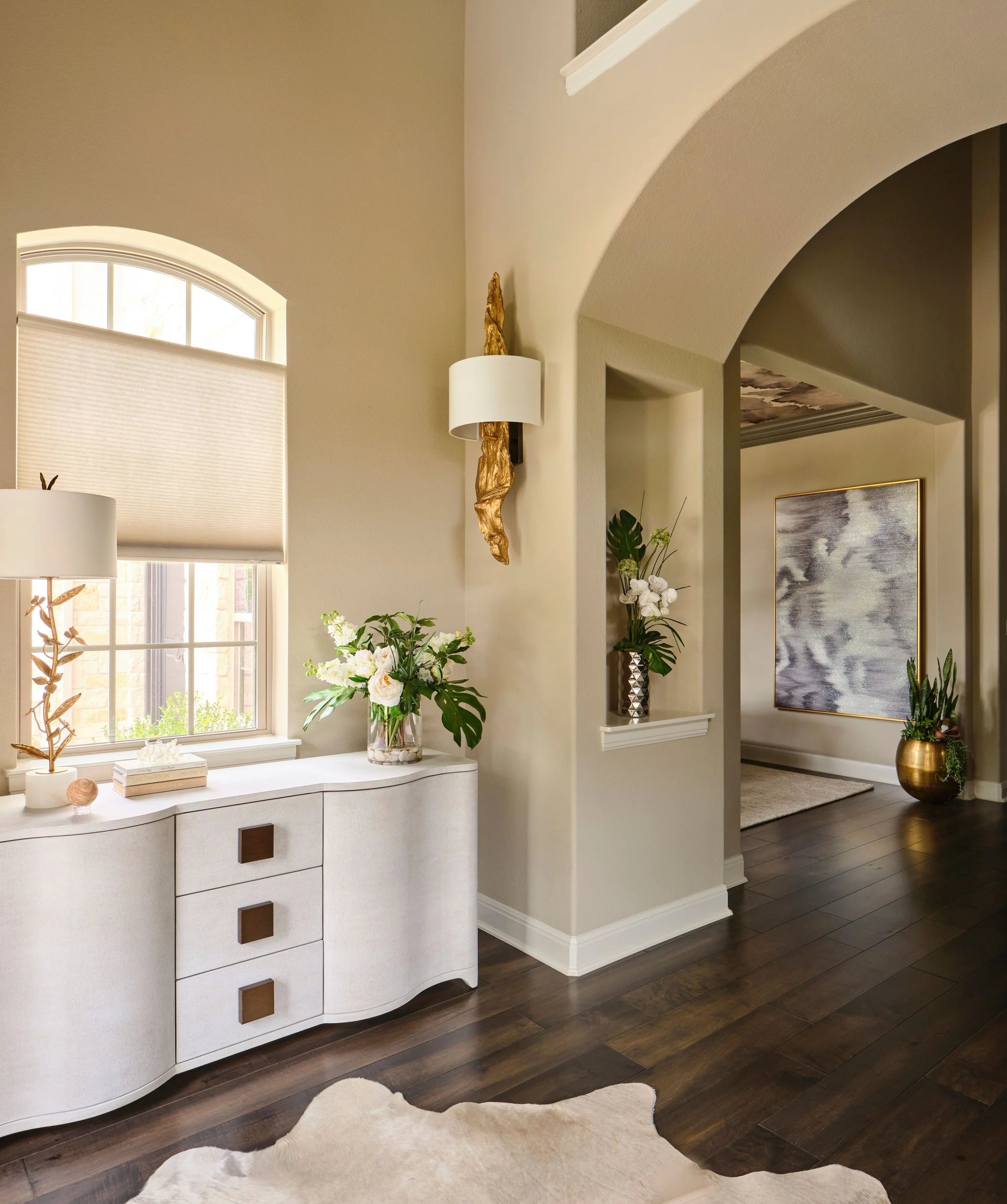 The connection between the foyer and hallway is designed to feel open and inviting, with soft architectural lines and curated details guiding the flow. This moment reflects a broader approach to designing the home as a cohesive, livable environment.