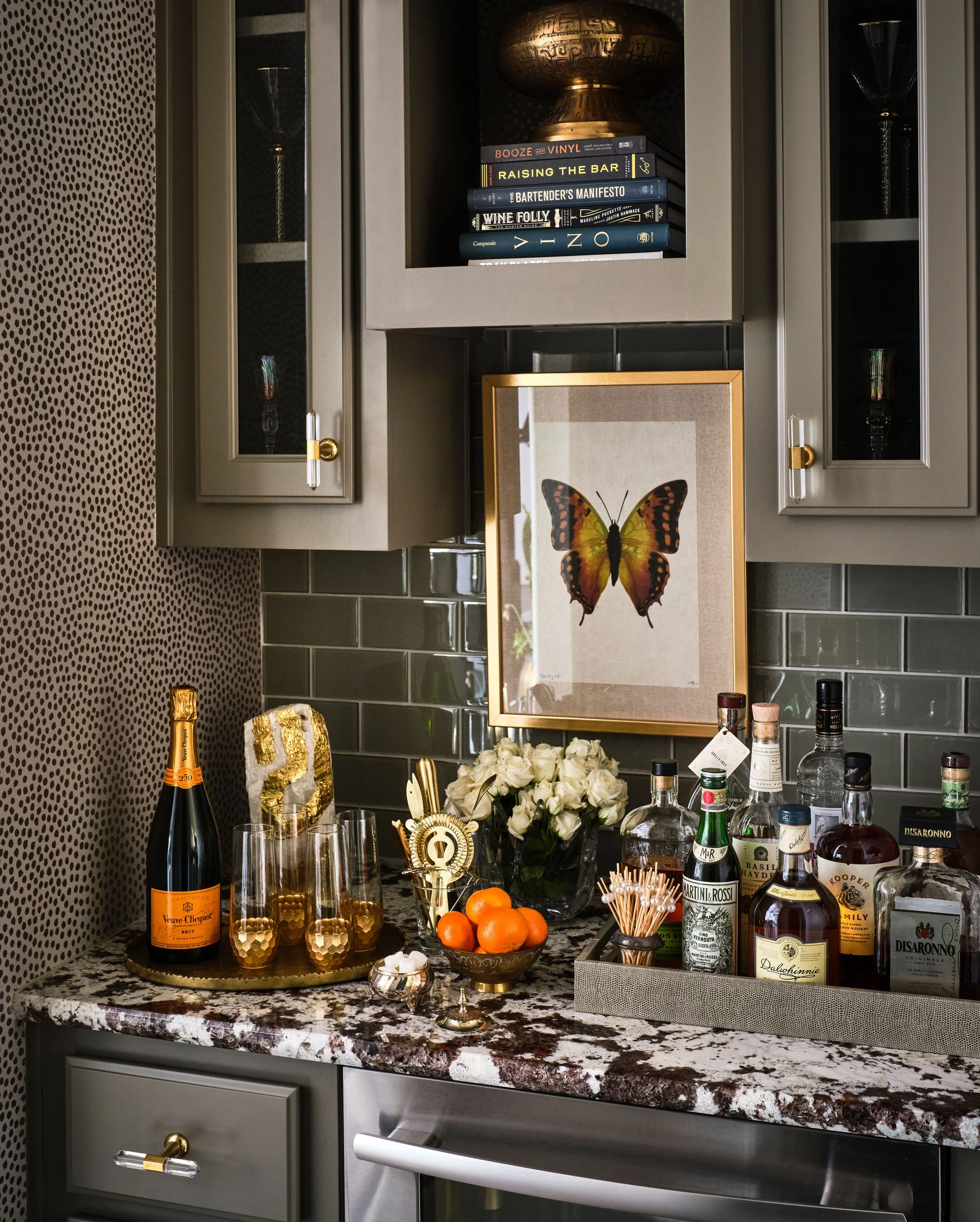 This built in wine bar blends custom cabinetry, stone surfaces, and curated styling to create a functional and inviting space for entertaining. Designed to support both storage and serving, it adds warmth, personality, and a sense of everyday luxury 