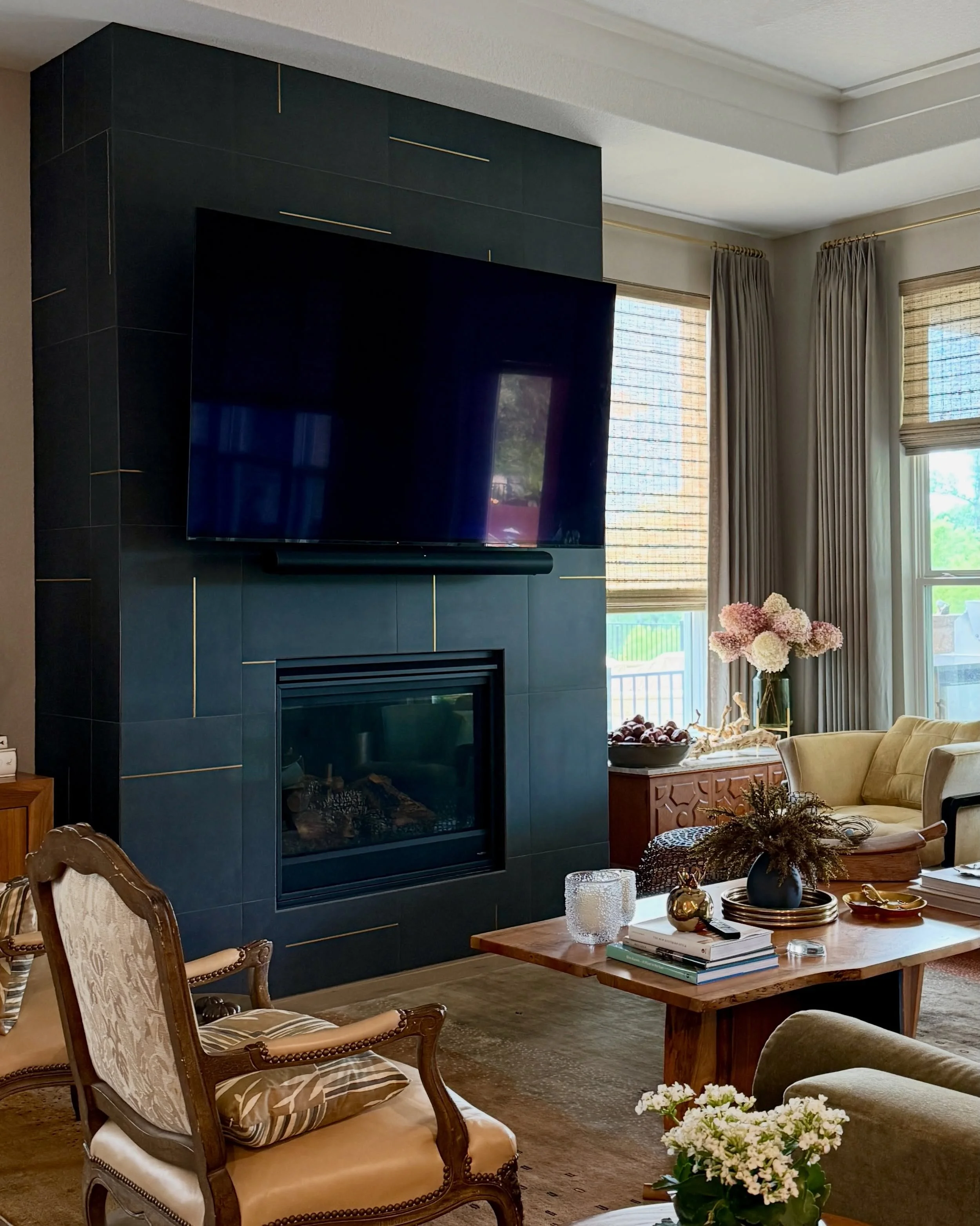 There is a big difference between decorating a room and giving it presence.

This living room was part of a larger personalization project where we layered in custom window coverings, a dramatic fireplace transformation, lighting, and thoughtful deta