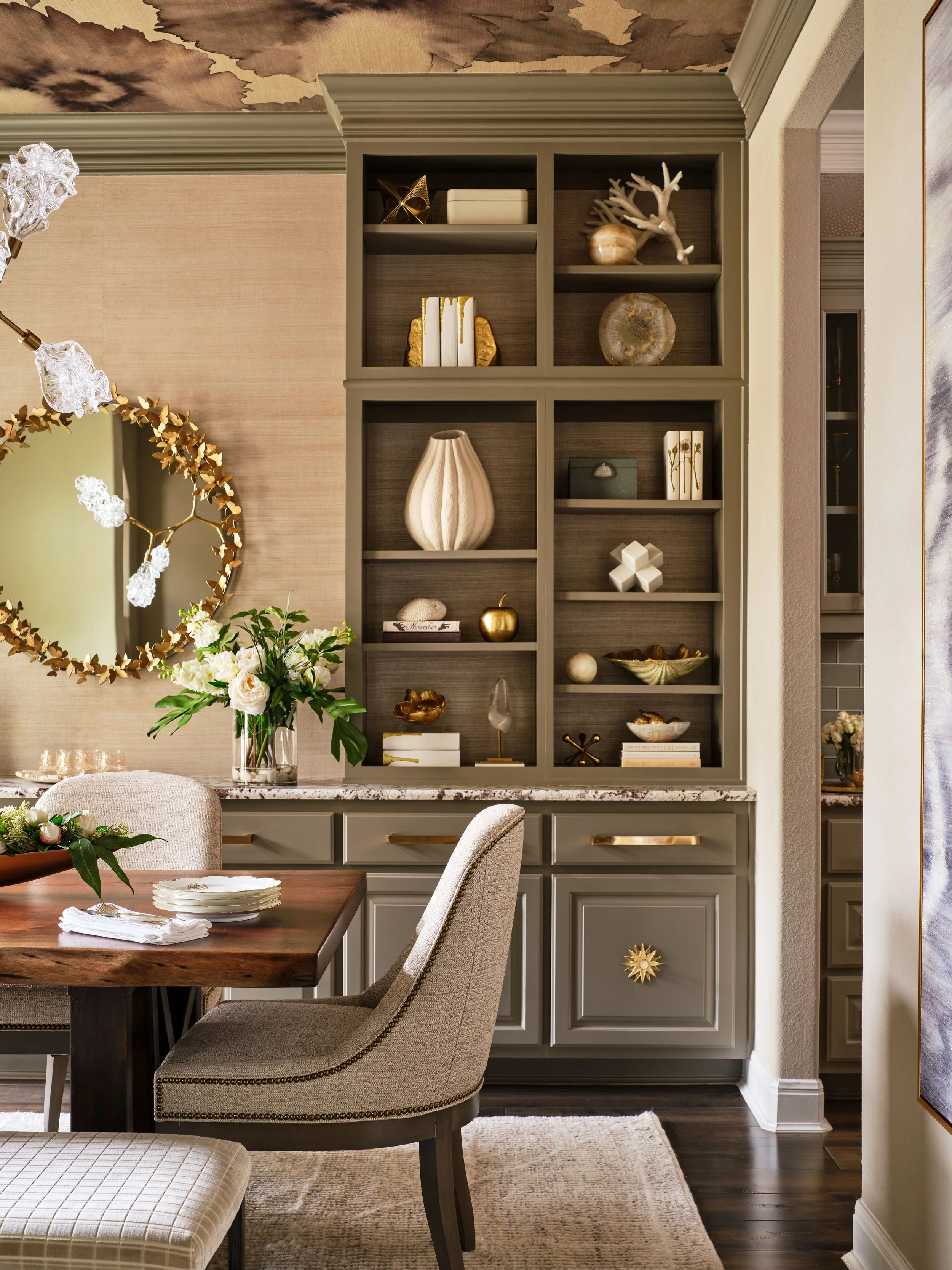 Custom built in cabinetry in this dining room was designed to bring both function and depth to the space. Styled with a thoughtful mix of objects and materials, the millwork adds warmth, texture, and a collected feel that enhances the overall design.