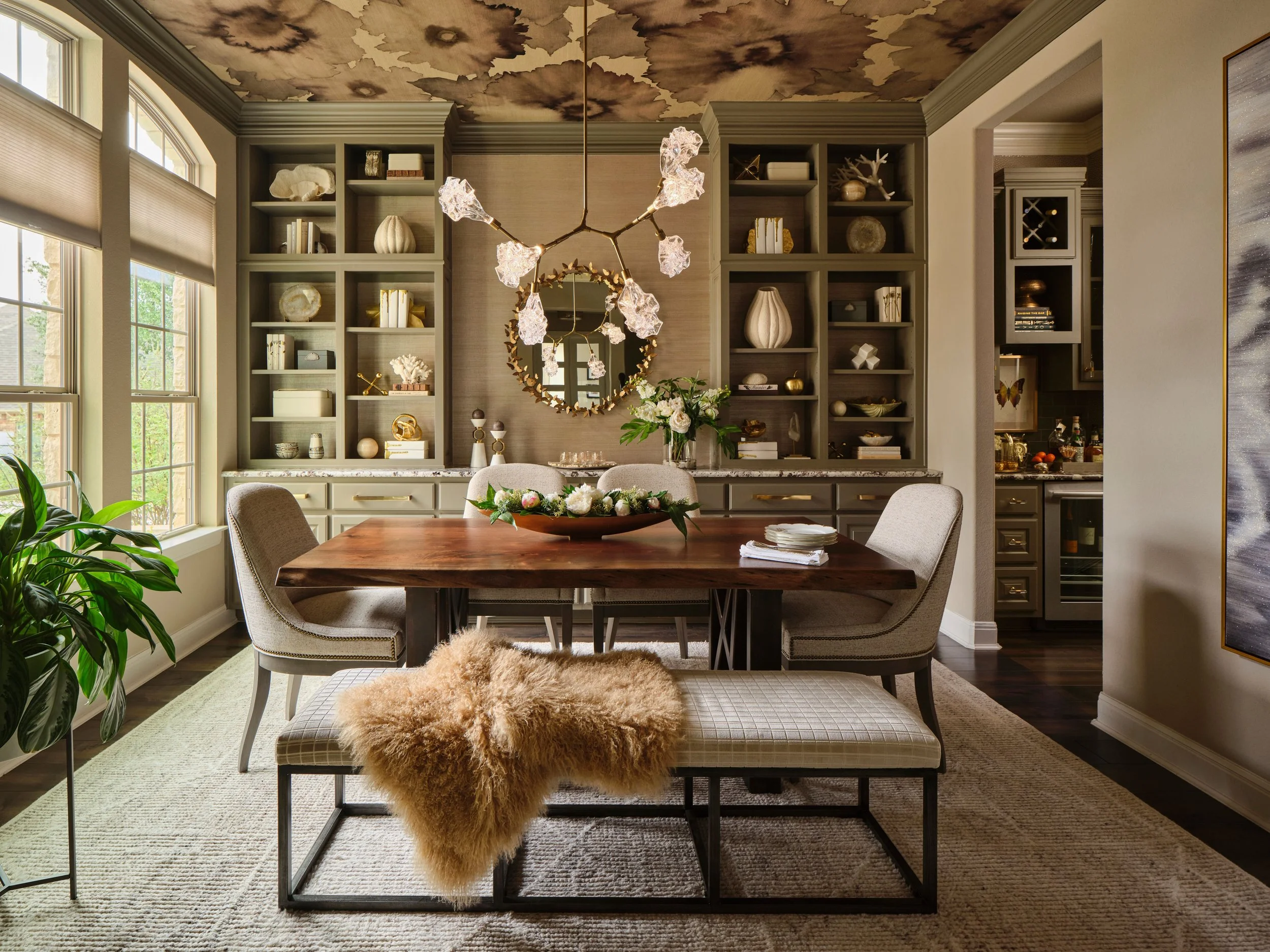 This dining room at the Gabriel Woods project reflects a layered and refined approach to luxury interior design in the Austin Hill Country. Custom furnishings, textured wallcovering, and tailored millwork are anchored by a statement chandelier, creat