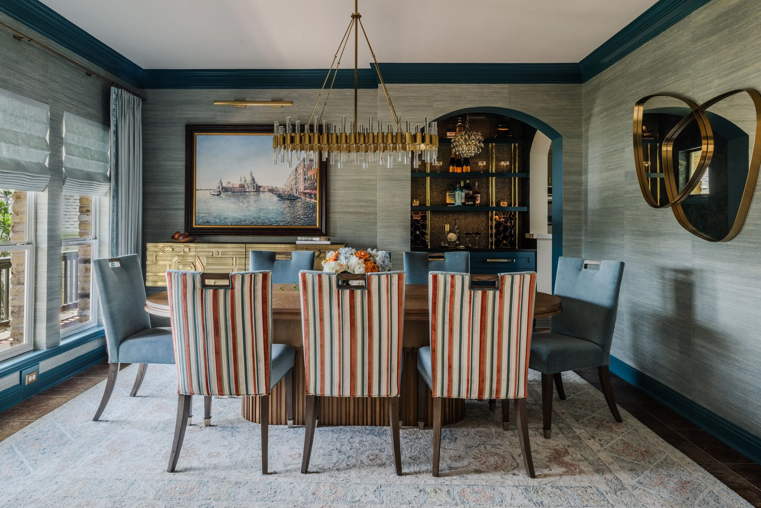 This dining room at the Gabriel Woods project reflects Cyndi Hopkins Design’s layered approach to luxury residential interiors in the Austin area. Custom furnishings, textured wallcovering, and statement lighting create a refined yet welcoming entert