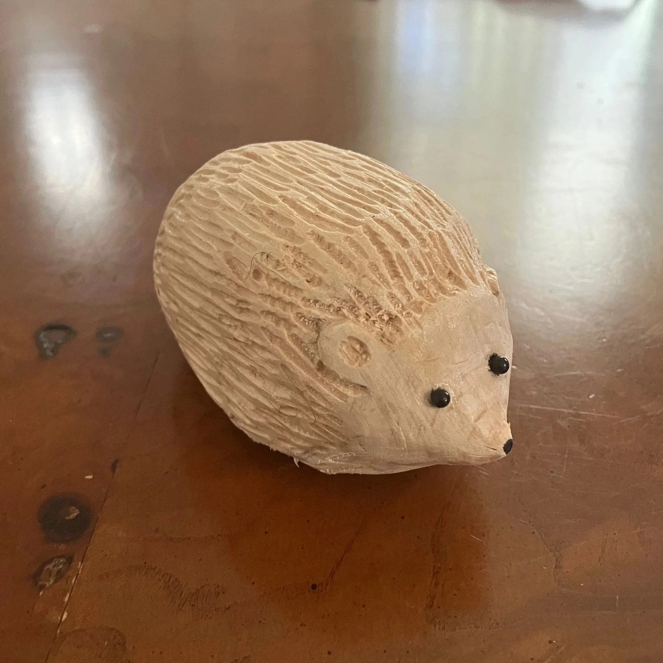 hand carved wood hedgehog toy, glass eyes